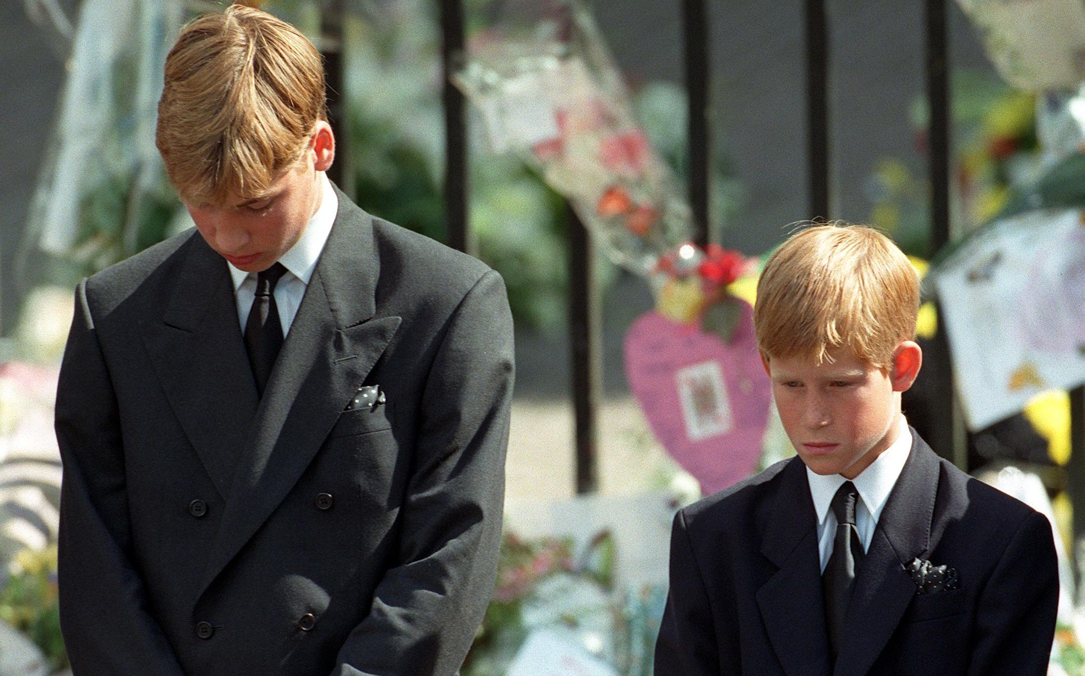 Prince William (left) and Prince Harry, the sons of Diana, Princess of Wales, bow their heads as their mother's coffin is taken out of Westminster Abbey following her funeral service (Adam Butler/PA Wire)