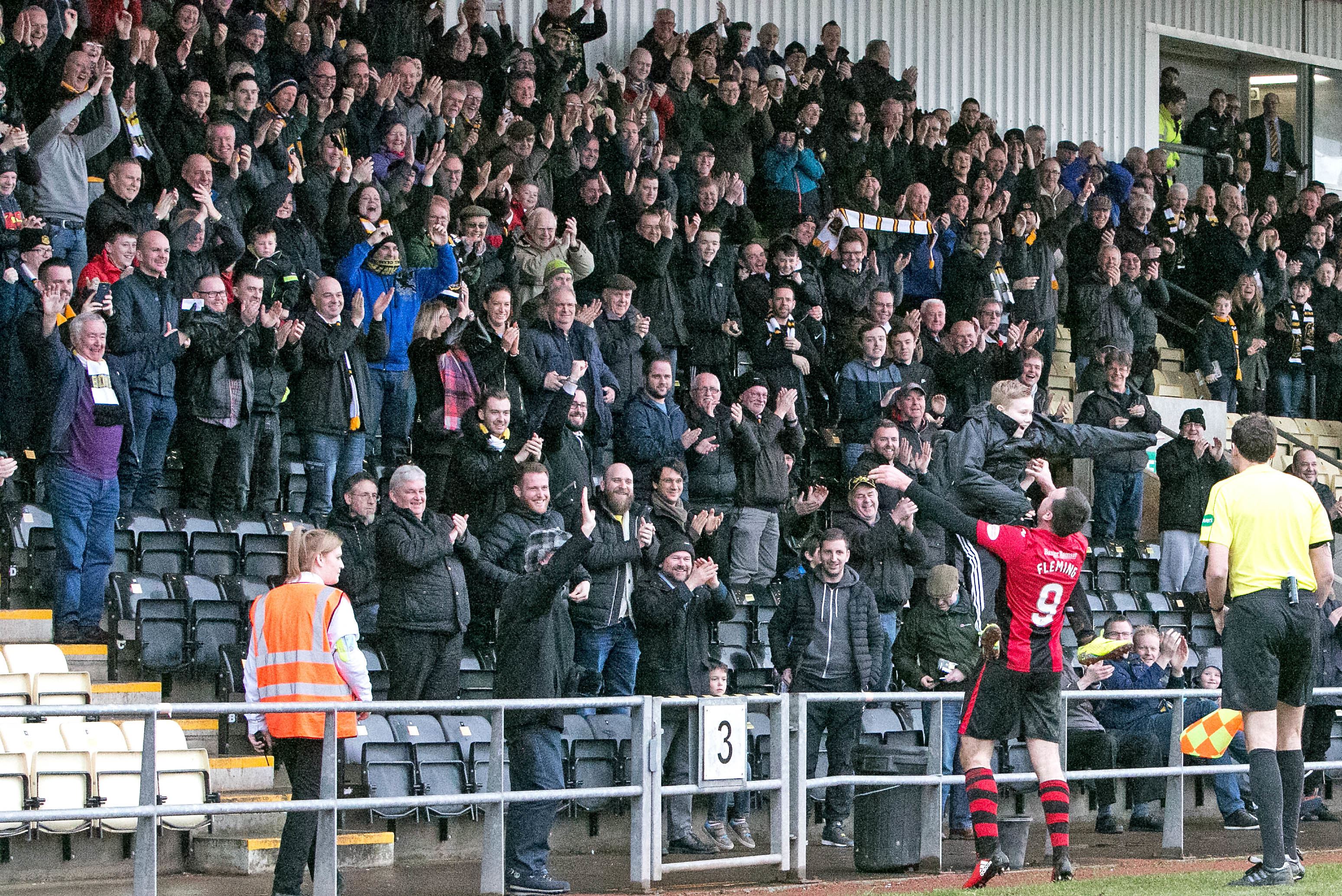 A ball boy celebrates with Dumbarton's Gary Fleming after he scores against Raith Rovers (Donald Fullarton)