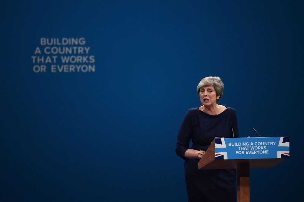 Letters begin to fall off the backdrop as Theresa May delivers her speech (Carl Court/Getty Images)