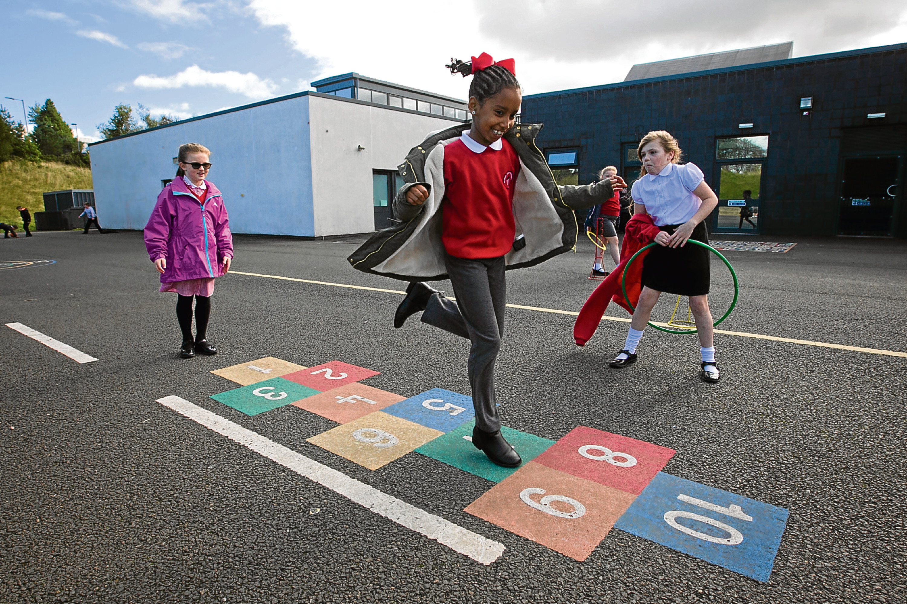 School children playing various outdoor games at Avenue End Primary School, near Easterhouse, in Glasgow (Andrew Cawley / DC Thomson)