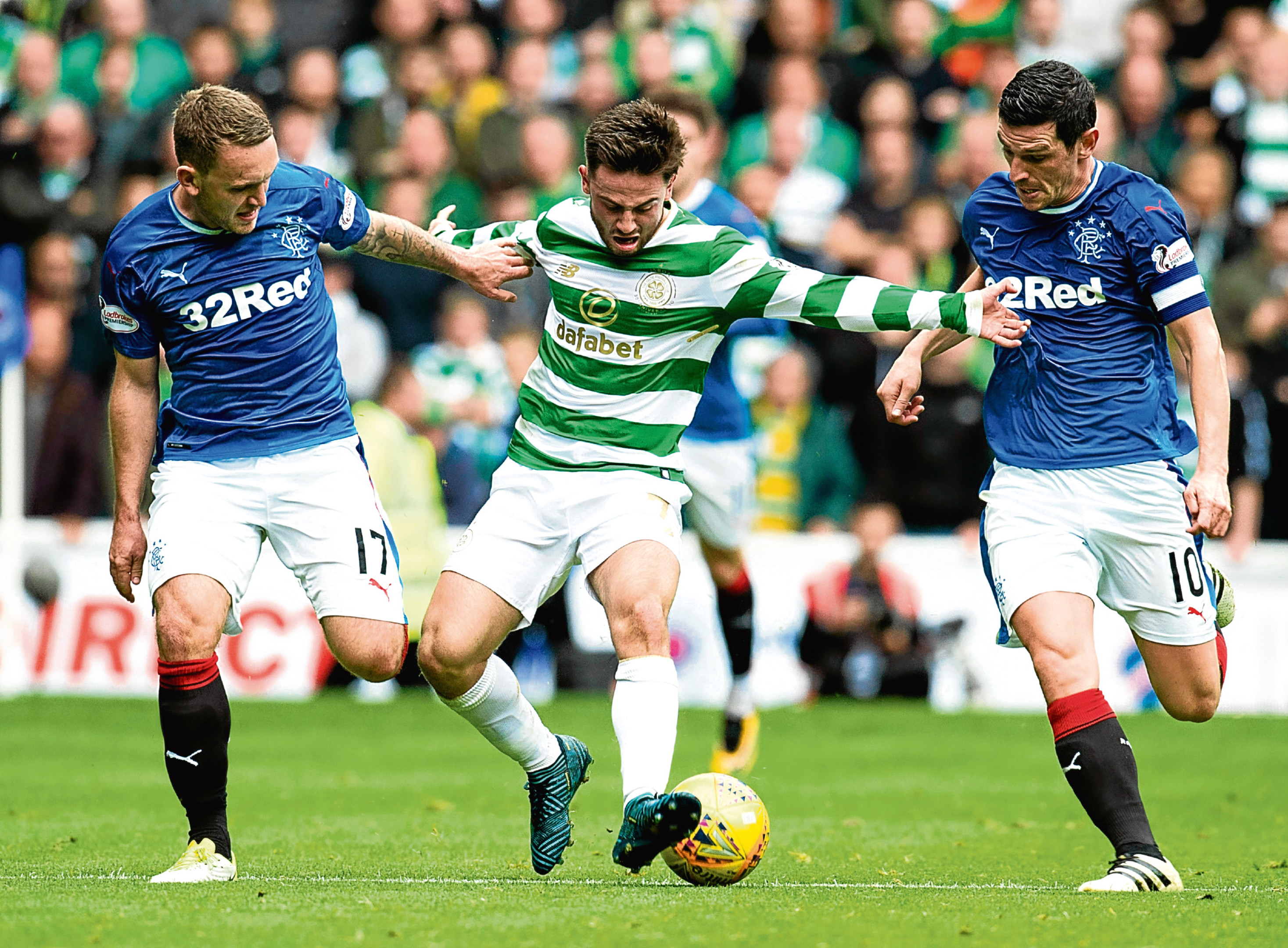Celtic's Patrick Roberts (centre) holds off Rangers' Lee Hodson and Graham Dorrans in last month's derby (SNS Group)