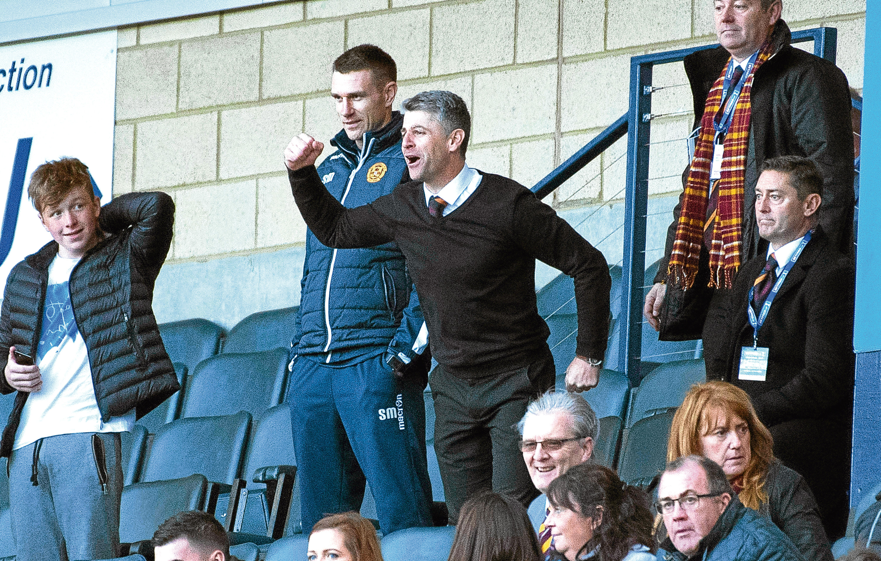 Motherwell manager Stephen Robinson celebrates in the stands. (SNS)