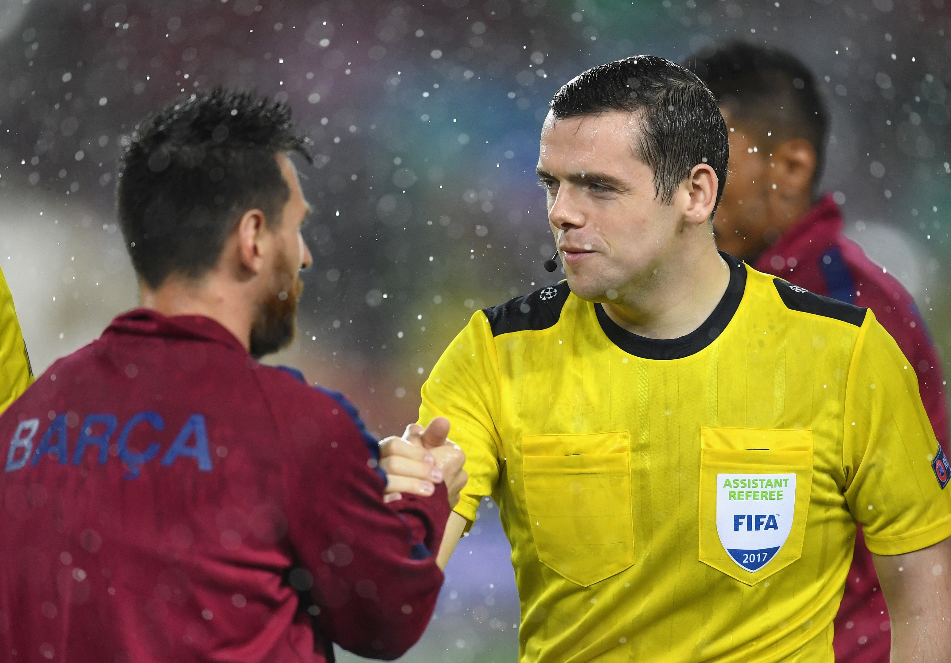 Assistant referee Douglas Ross  shakes hands with Lionel Messi after the Champions League match between Barcelona and Olympiakos Piraeus (David Ramos/Getty Images)