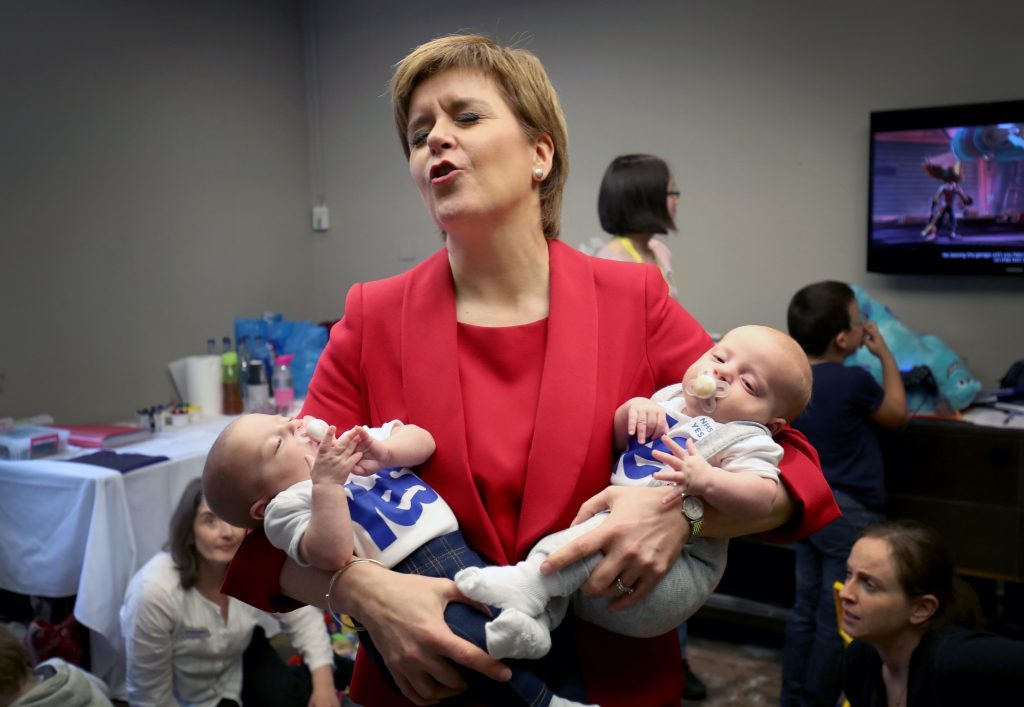 First Minister Nicola Sturgeon with 13-week-old twins Catherine (left) and Sam Shepherd, from Kirkintilloch, in the creche at the Scottish National Party conference at the SEC Centre in Glasgow. (PA)