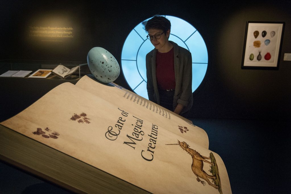 A visitor looks at a book of Care Of Magical Creatures during a press preview for the Harry Potter: A History of Magic exhibition at the British Library (Victoria Jones/PA)