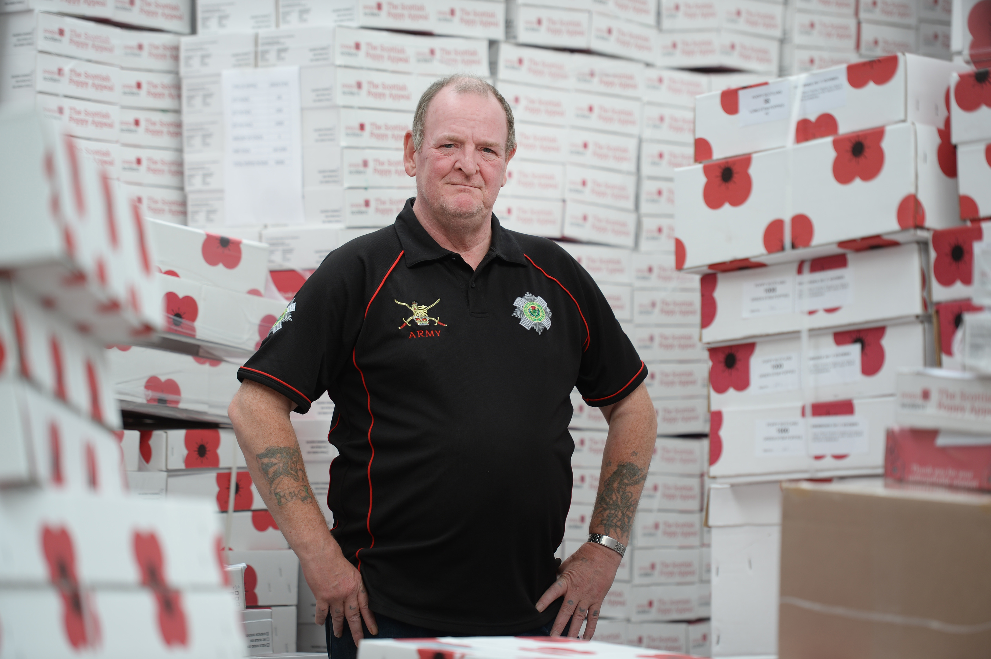 Veteran Donald with boxes of poppies