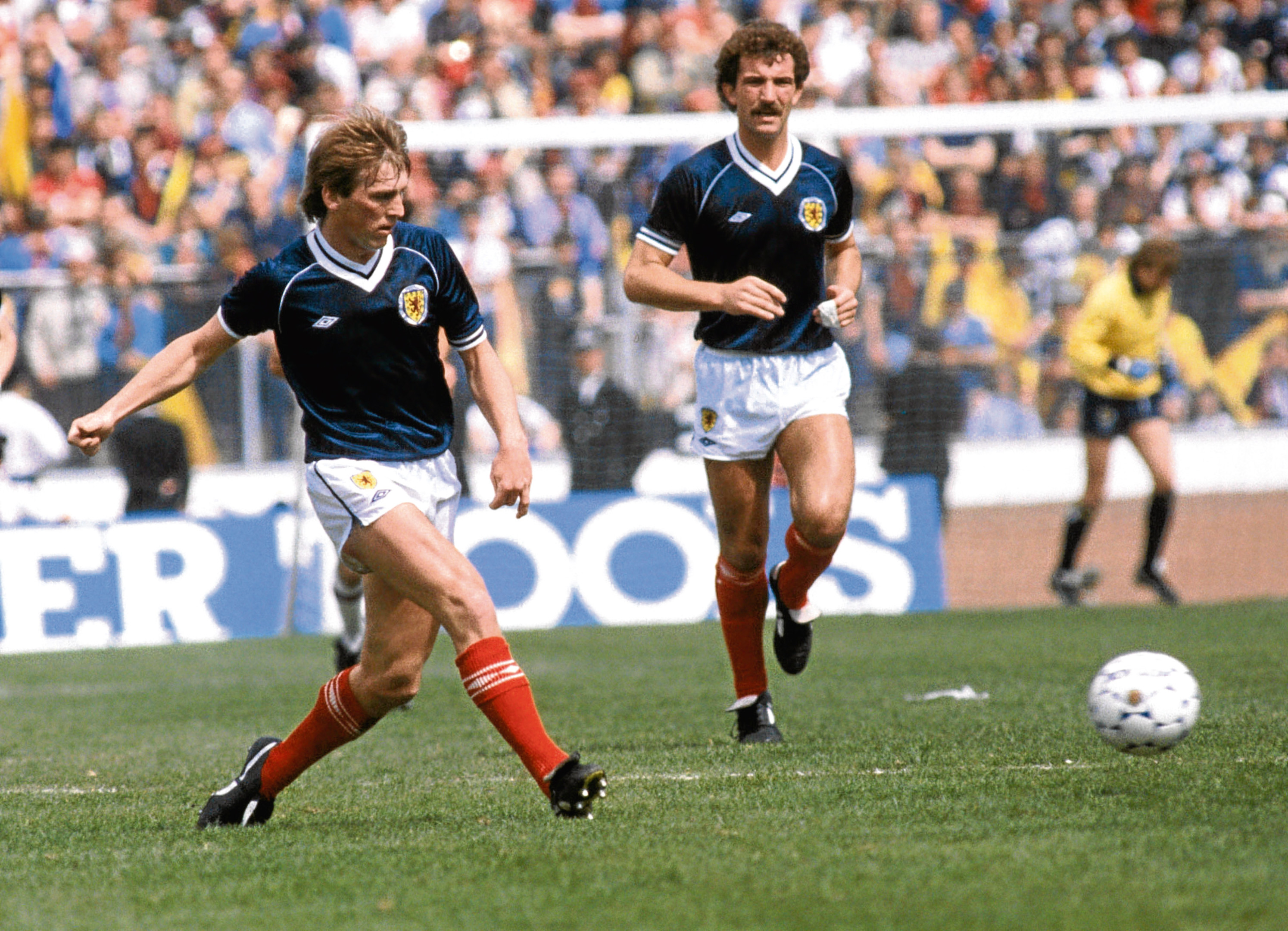 Scotland's Kenny Dalglish (left) passes the ball watched by Graeme Souness
