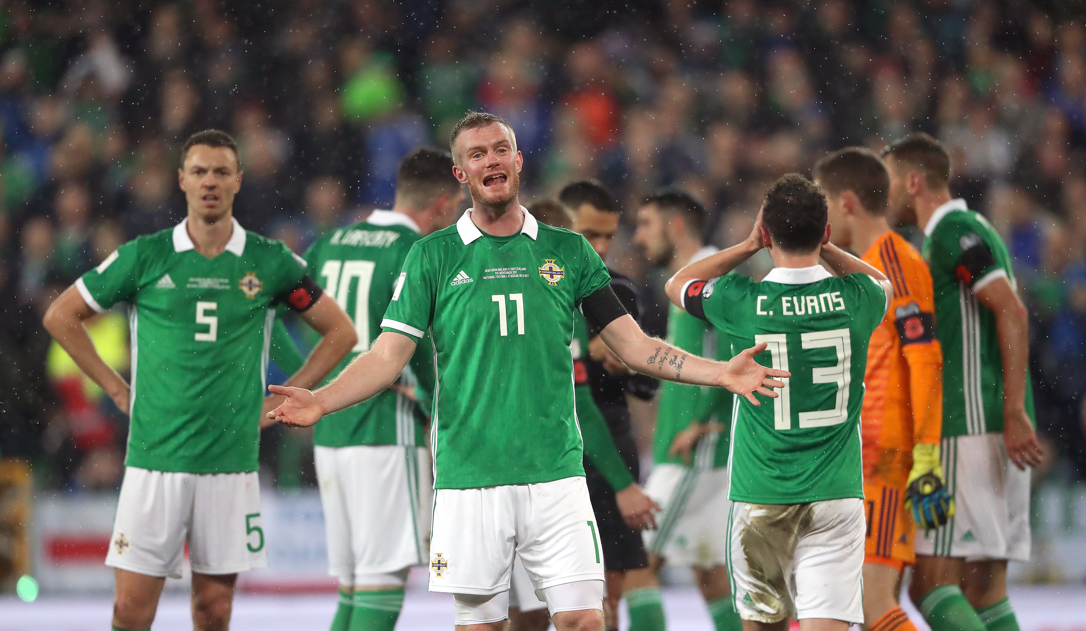 Northern Ireland's Chris Brunt (centre) reacts after Corry Evans concedes a penalty for handball (Niall Carson / PA Wire)