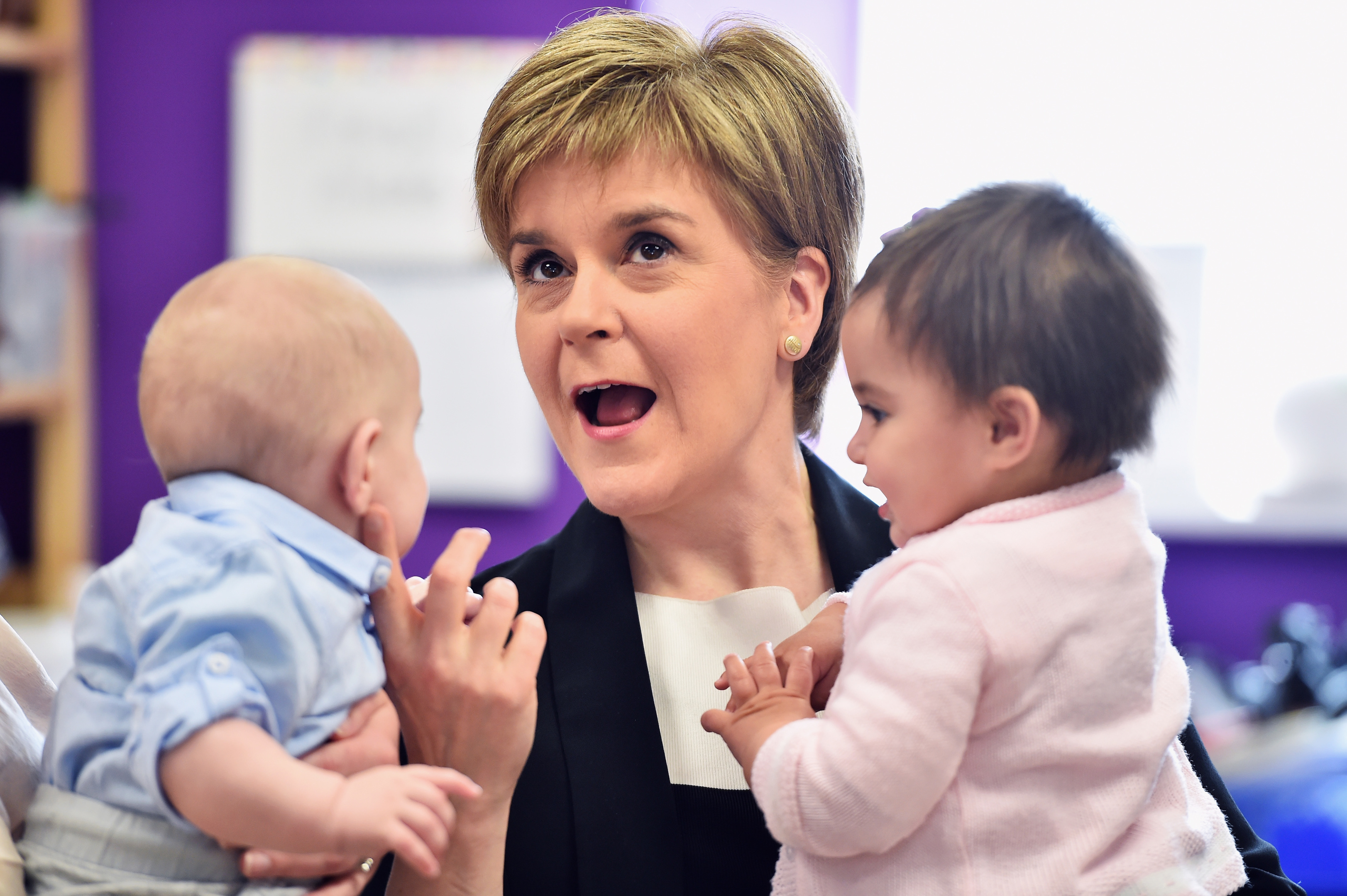 Nicola Sturgeon, seen spending time with Leo Donegan and Nina Fredrick on a visit to Glasgow in April, has vowed to improve kids’ lives (Jeff J Mitchell/Getty Images)