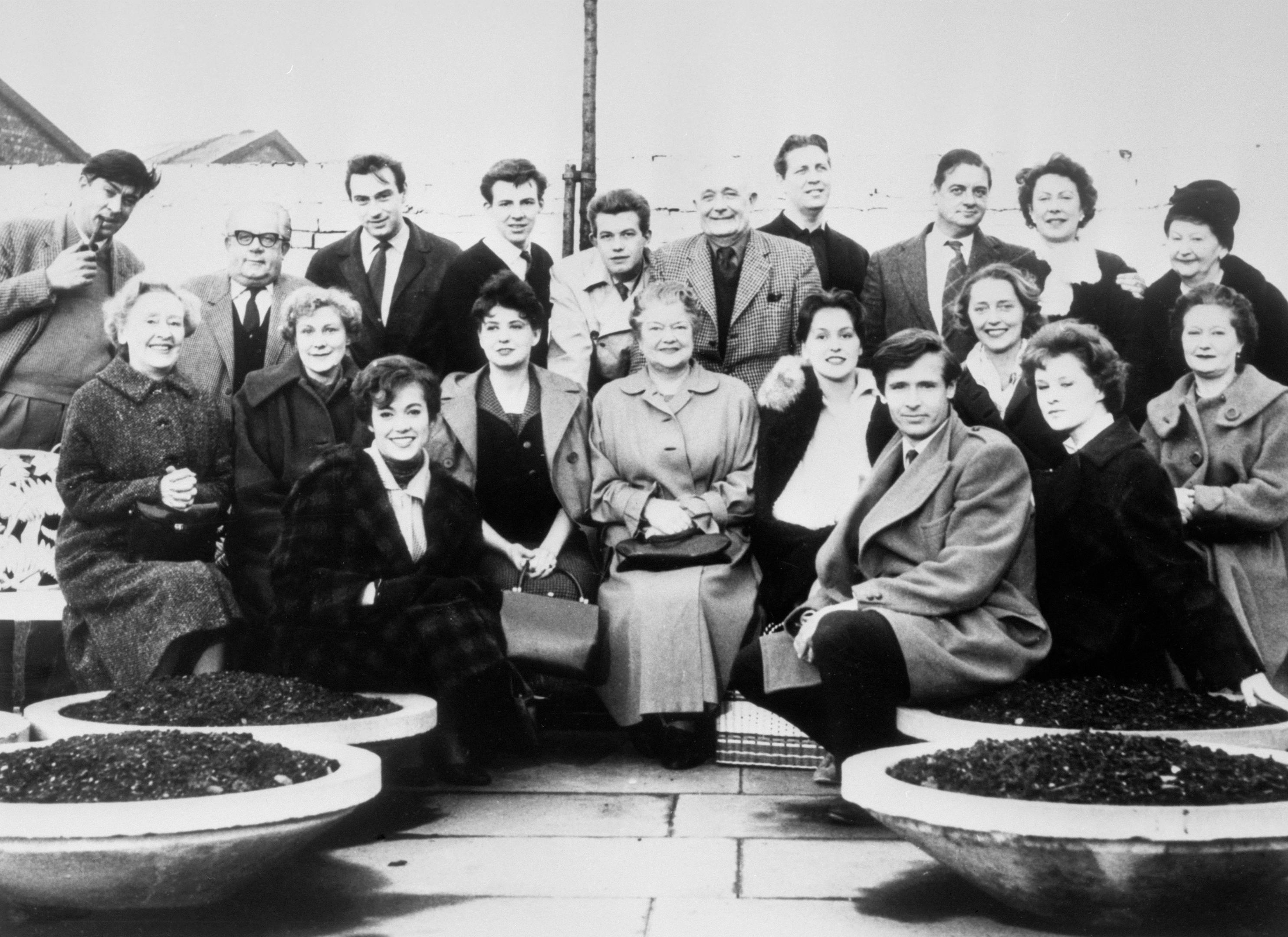 The cast of Coronation Street in the Granada TV Centre car park in Manchester, between rehearsals for the first programme networked on December 9, 1960 (PA Archive)