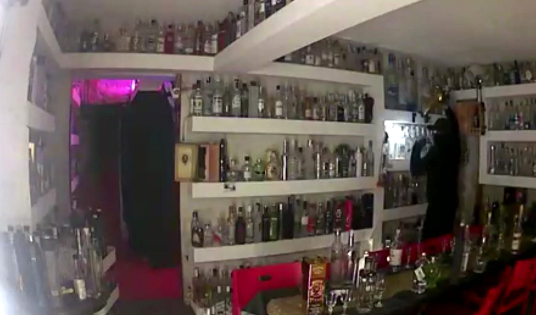 Image taken from CCTV showing a man stealing a bottle of vodka from Cafe 33 bar in Copenhagen (Brian Ingberg via AP)