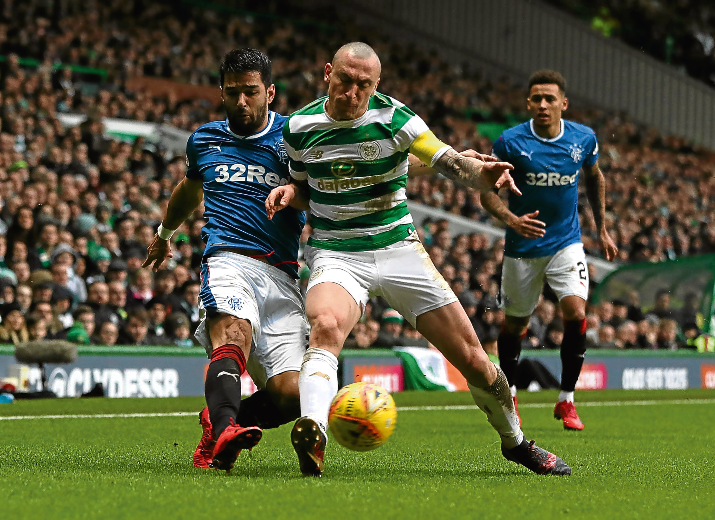Scott Brown vies with Daniel Candeias in December's Old Firm clash (Ian MacNicol/Getty Images)