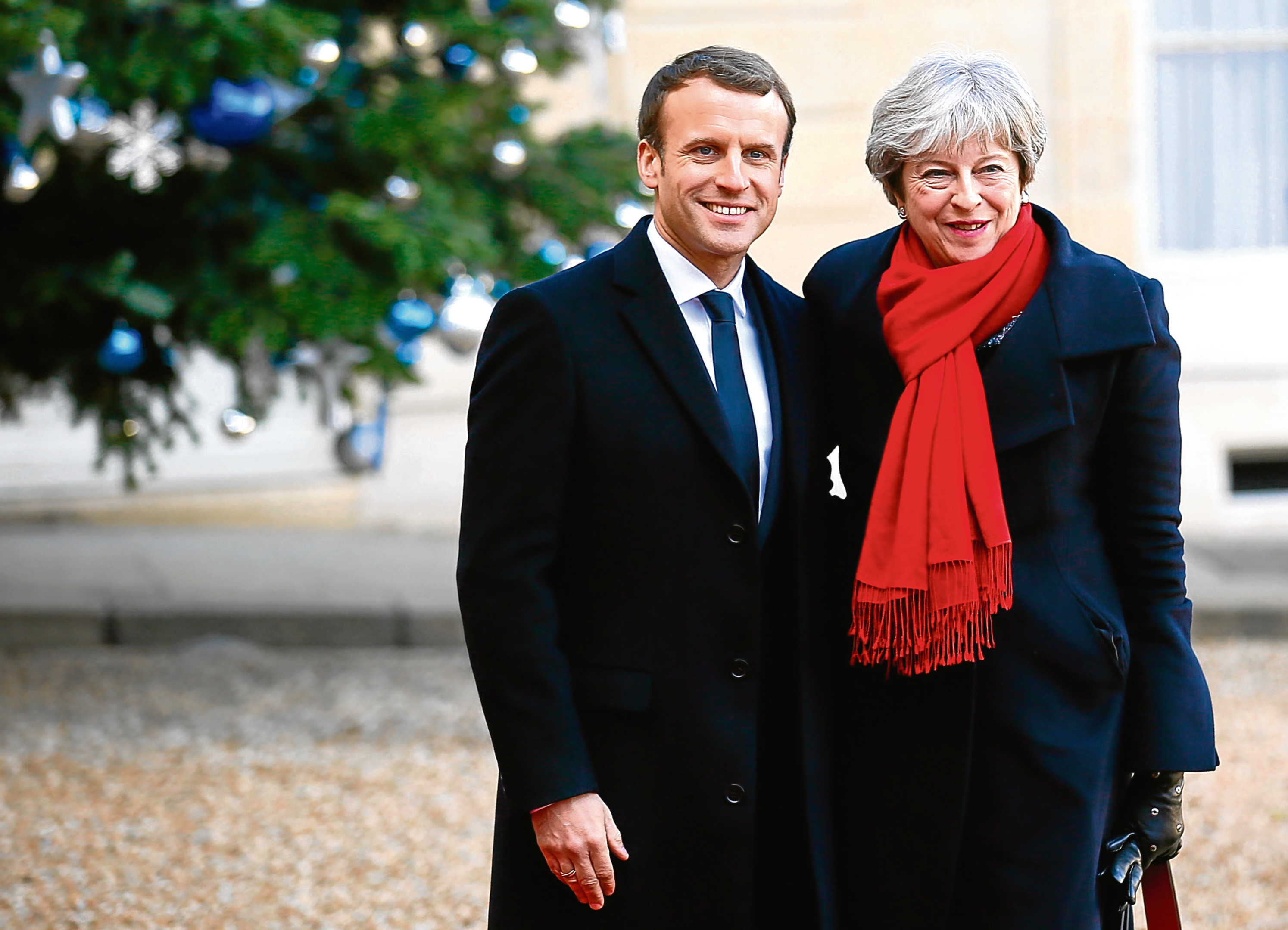 British Prime Minister Theresa May is welcomed by French President before a lunch at the Elysee Palace in Paris, Tuesday, Dec. 12, 2017. (AP Photo/Francois Mori)