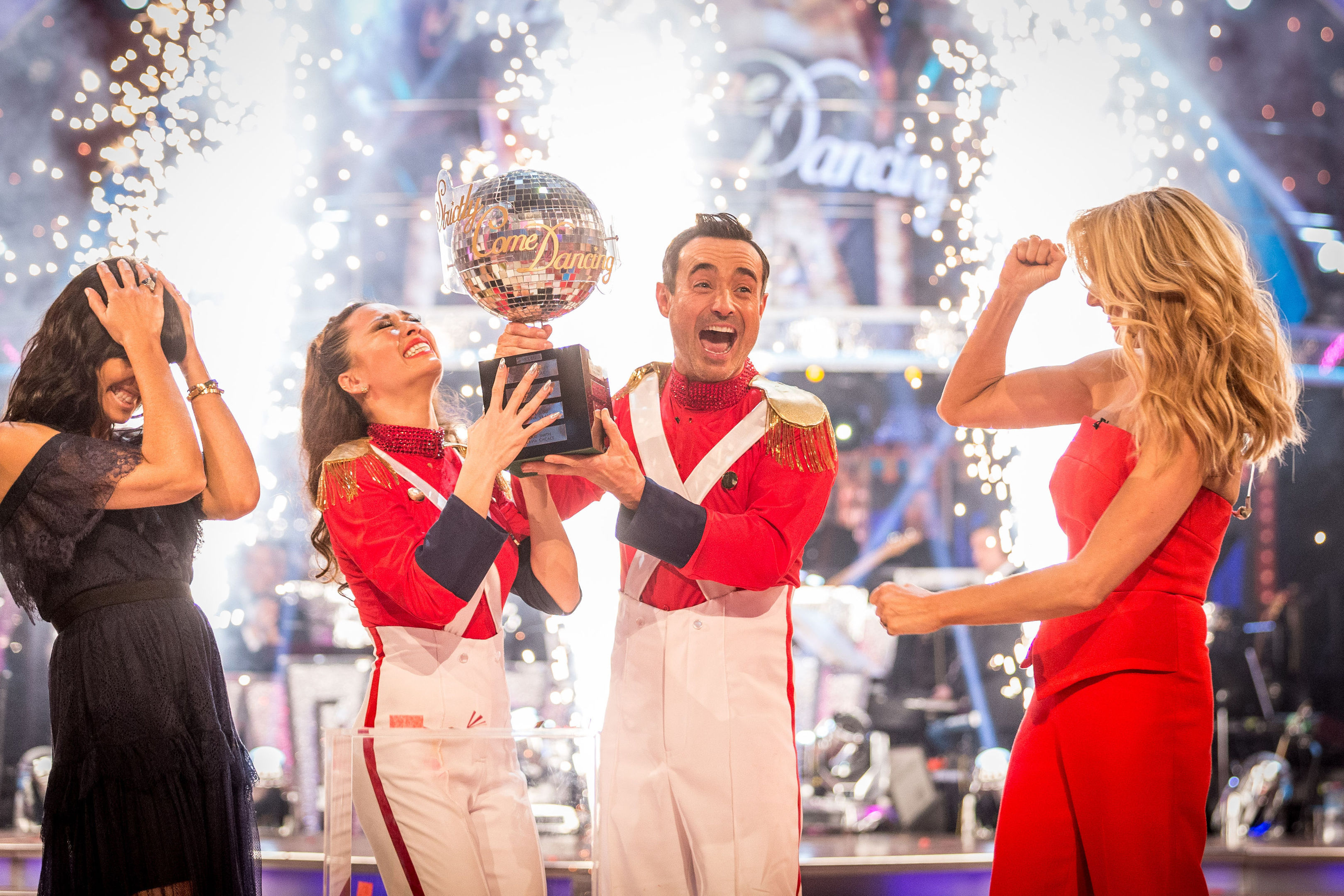 Claudia Winkleman (left) and Tess Daly (right) present Katya Jones and Joe McFadden with the glitterball trophy (Guy Levy/BBC/PA Wire)