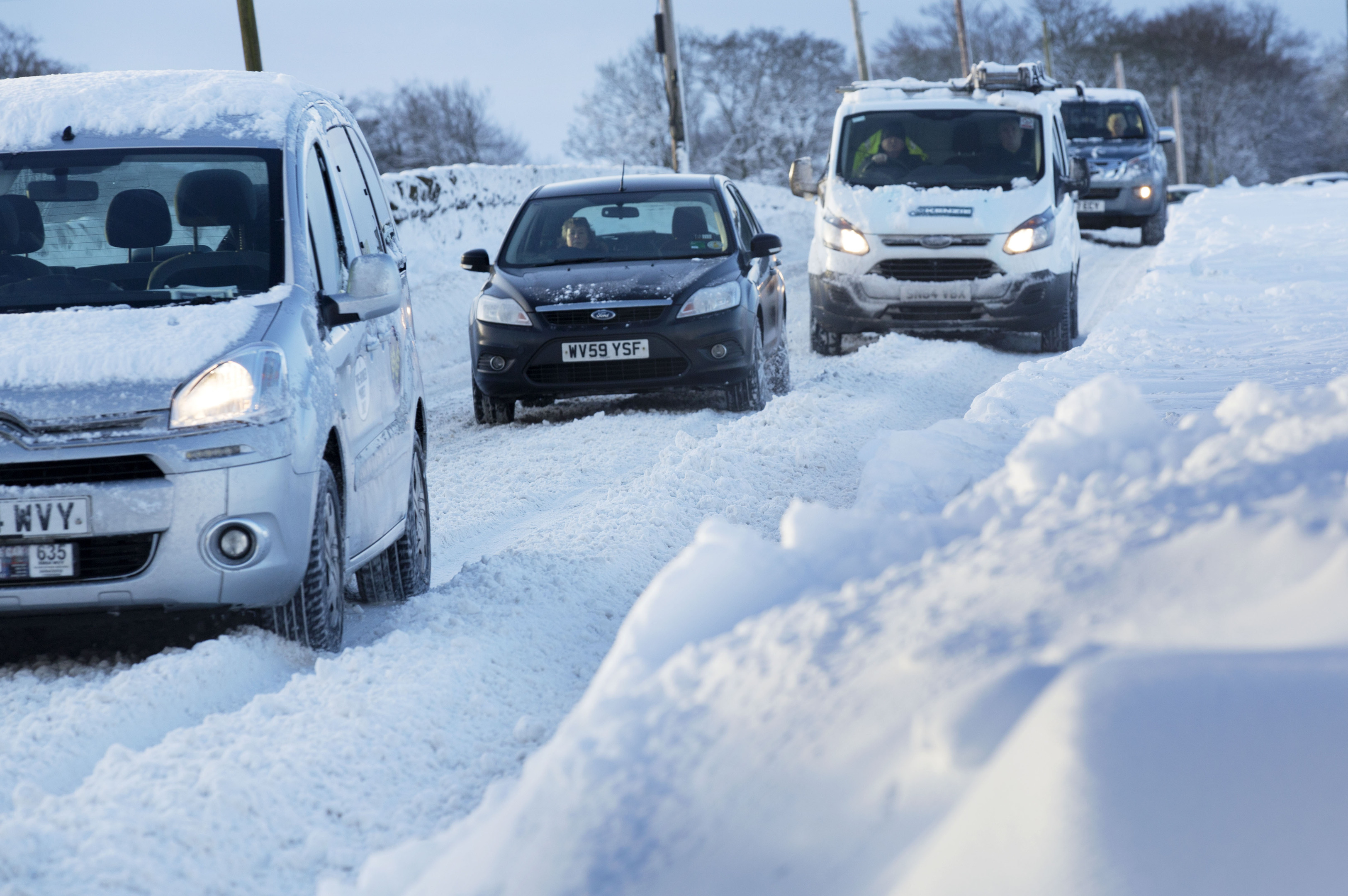 Vehicles make their way through heavy snow in Midlothian near Edinburgh. January 17, 2018. (David Cheskin/PA Wire)