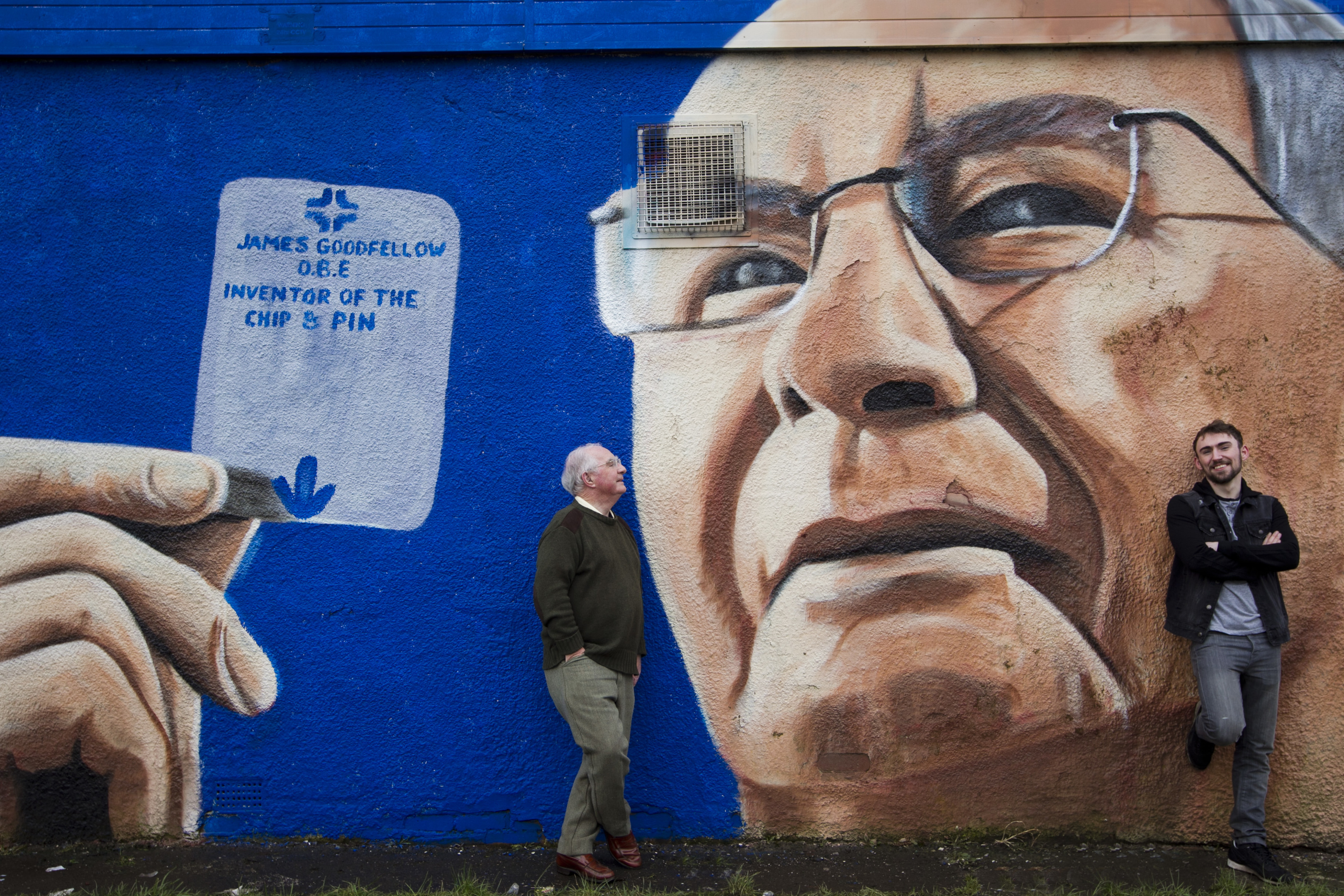 Graffiti artist Shaun Deveney, right, created the mural in Paisley in tribute to ATM inventor James Goodfellow, left            (Andrew Cawley / DC Thomson)