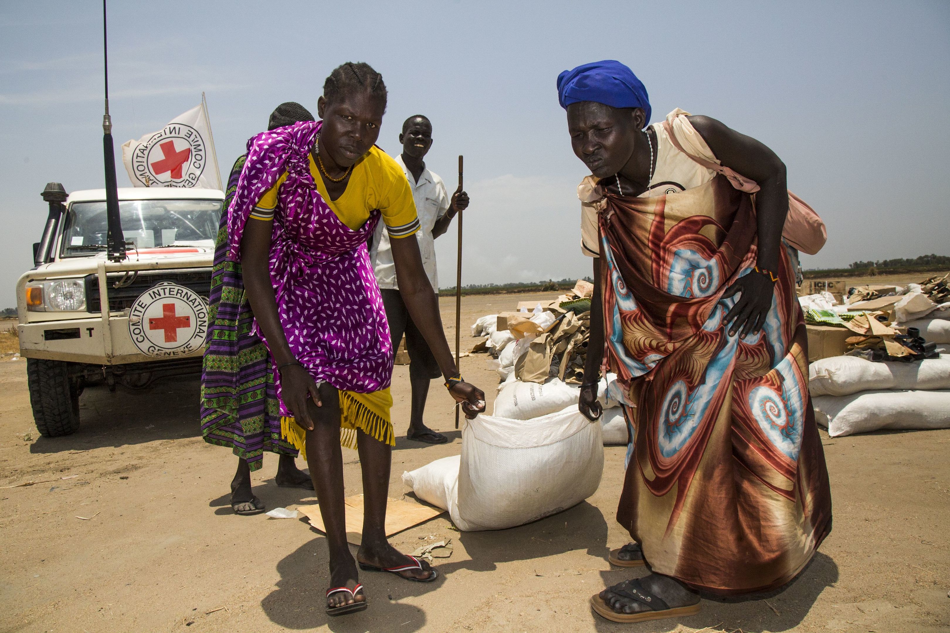 Women carry a sack of seeds distributed by the International Committee of the Red Cross (ICRC) in the opposition controlled town of Thonyor, in Leer county, on April 11, 2017.
( ALBERT GONZALEZ FARRAN/AFP/Getty Images)