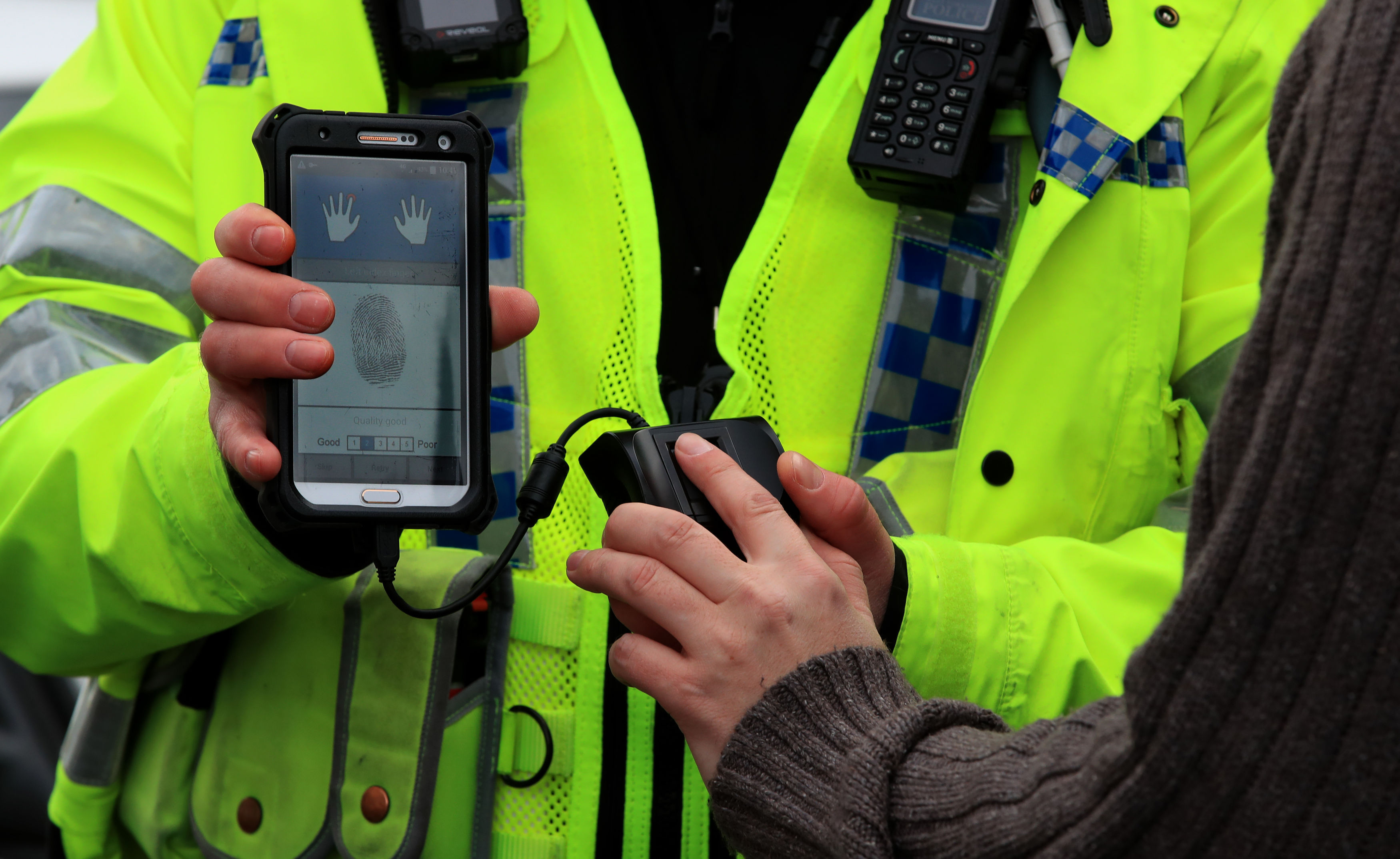 A West Yorkshire Police officer holding a new mobile fingerprint scanning system (Peter Byrne/PA Wire)