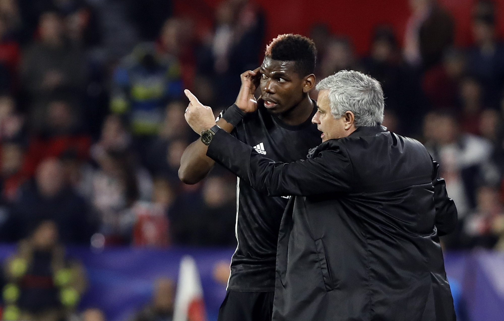 Jose Mourinho talks to  Paul Pogba during last night's Champions League match (AP Photo/Miguel Morenatti)