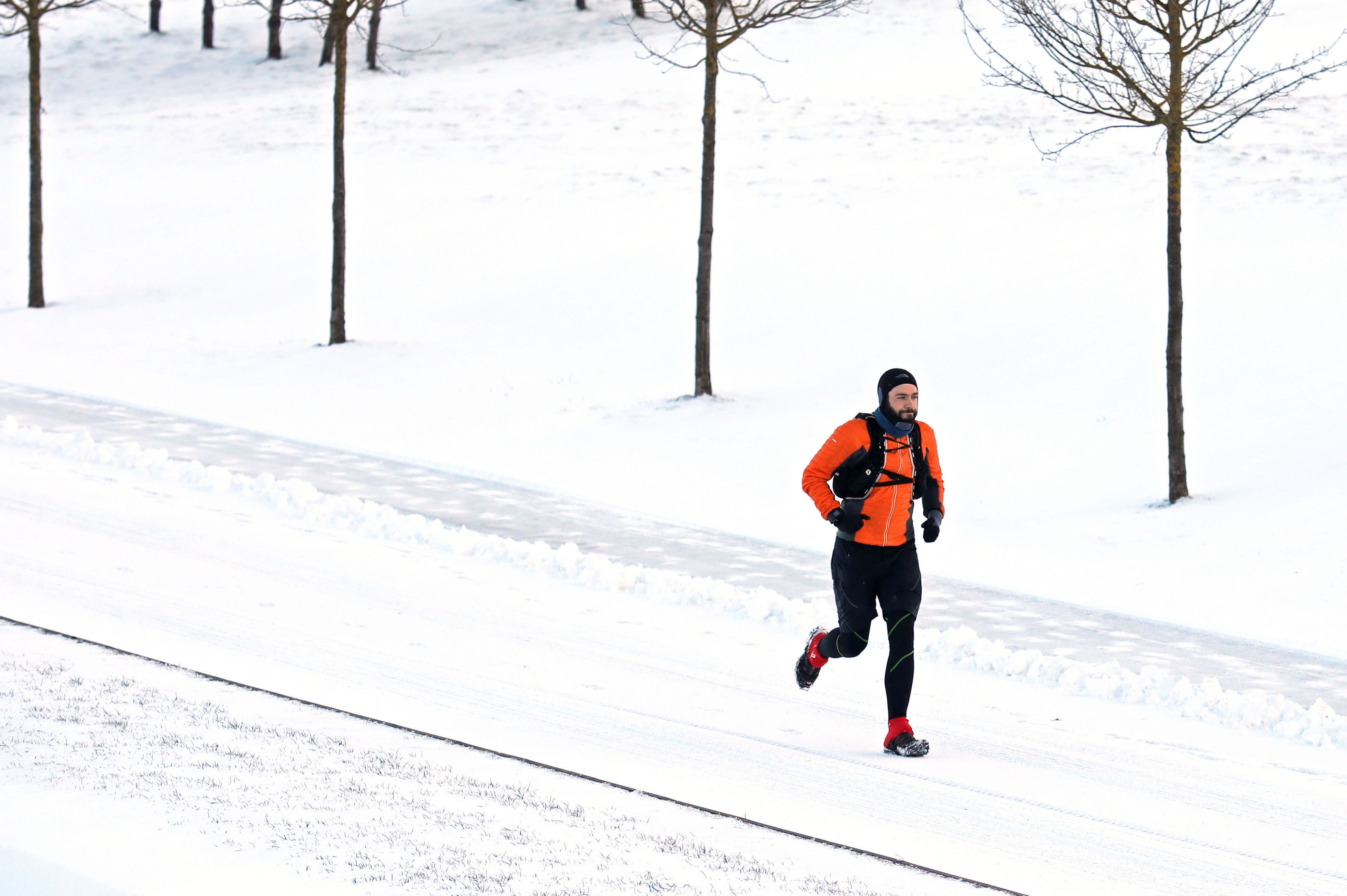 A man jogs through Helix Park in Falkirk, Scotland, as heavy snow has caused more misery for travellers overnight, with the wintry weather disruption set to continue during the morning rush hour. (Andrew Milligan/PA Wire)