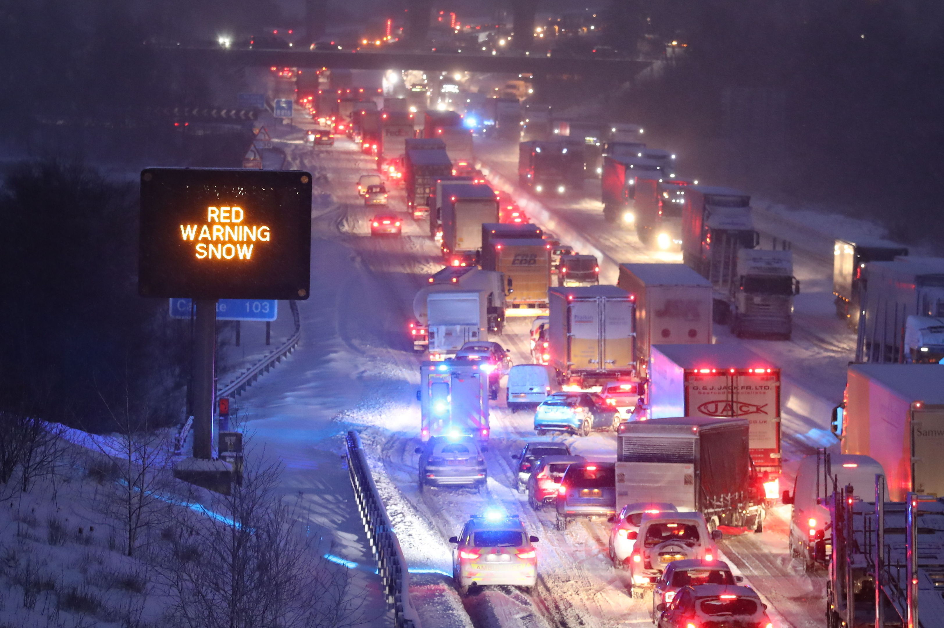 Emergency vehicles manoeuvre past stationary traffic on the M80 at Haggs (Andrew Milligan/PA)