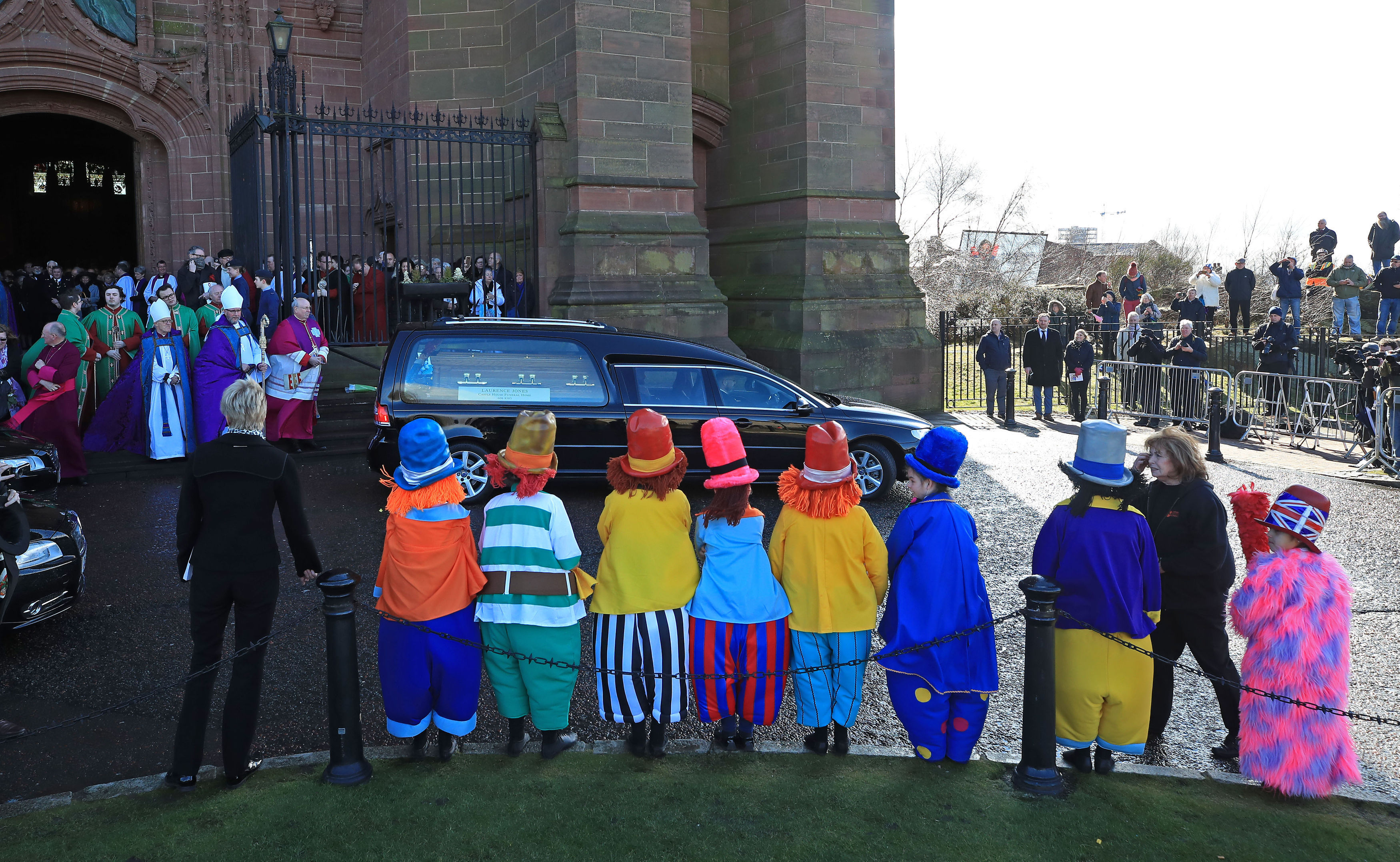 Children dressed as Diddymen watch the funeral cortege leave the Liverpool Anglican Cathedral (Peter Byrne/PA Wire)