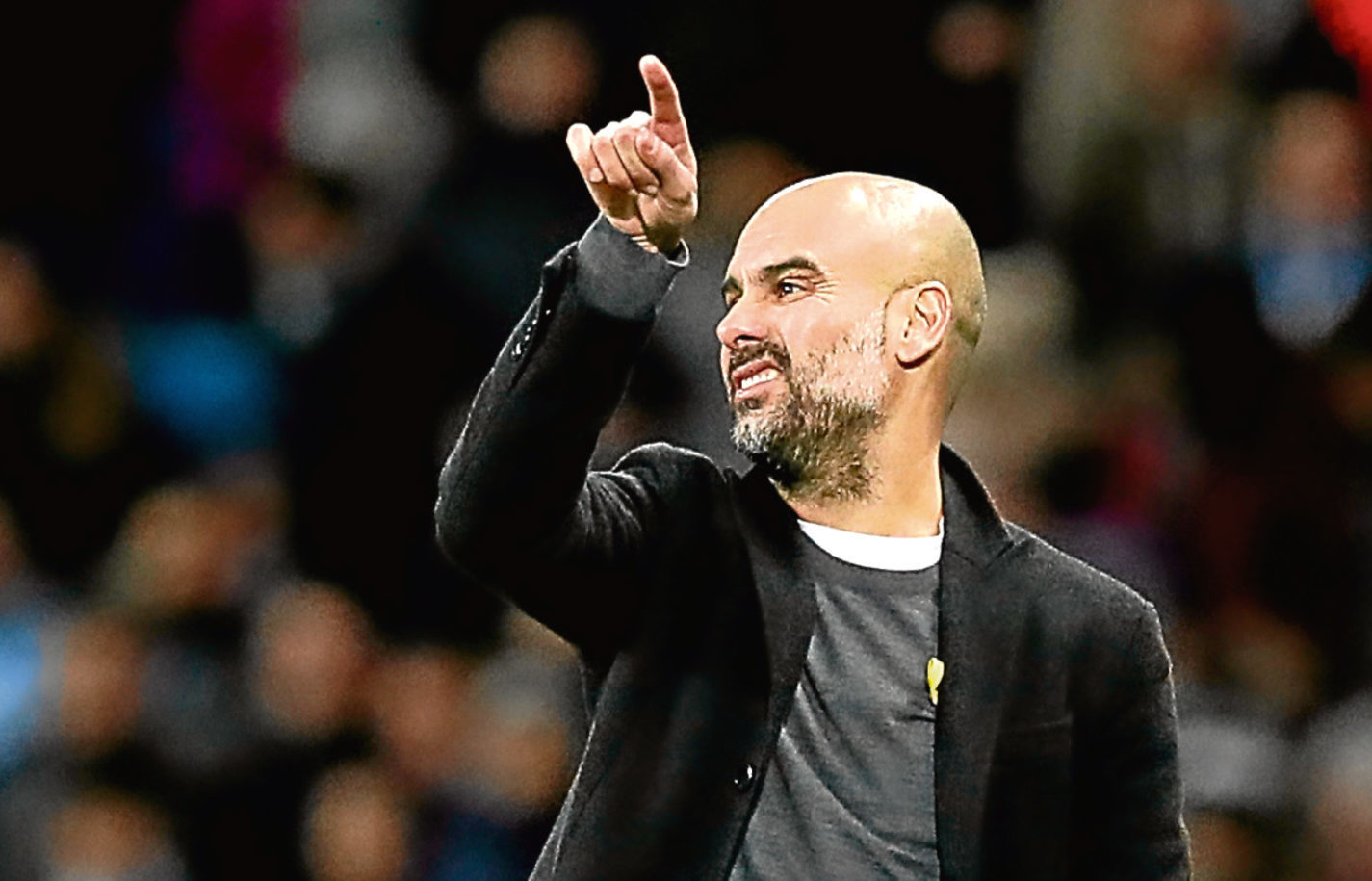 Manchester City manager Pep Guardiola on the touchline (Martin Rickett / PA Wire)