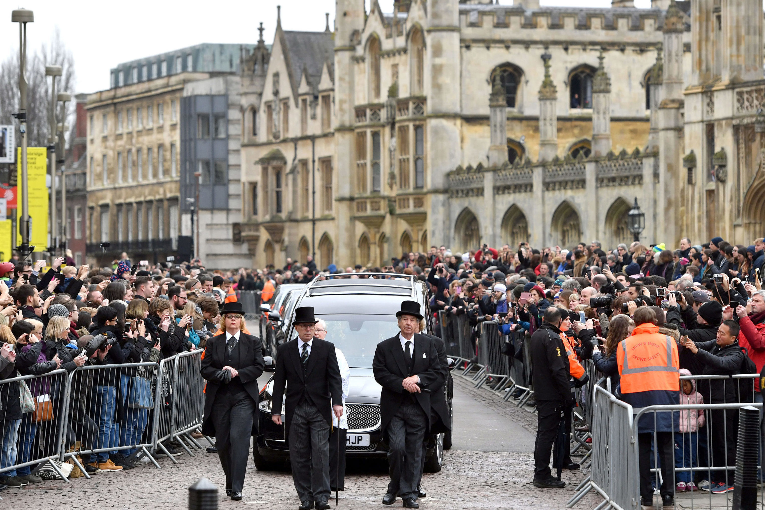 The hearse arrives at University Church of St Mary the Great in Cambridge, as mourners look on (Joe Giddens/PA Wire)