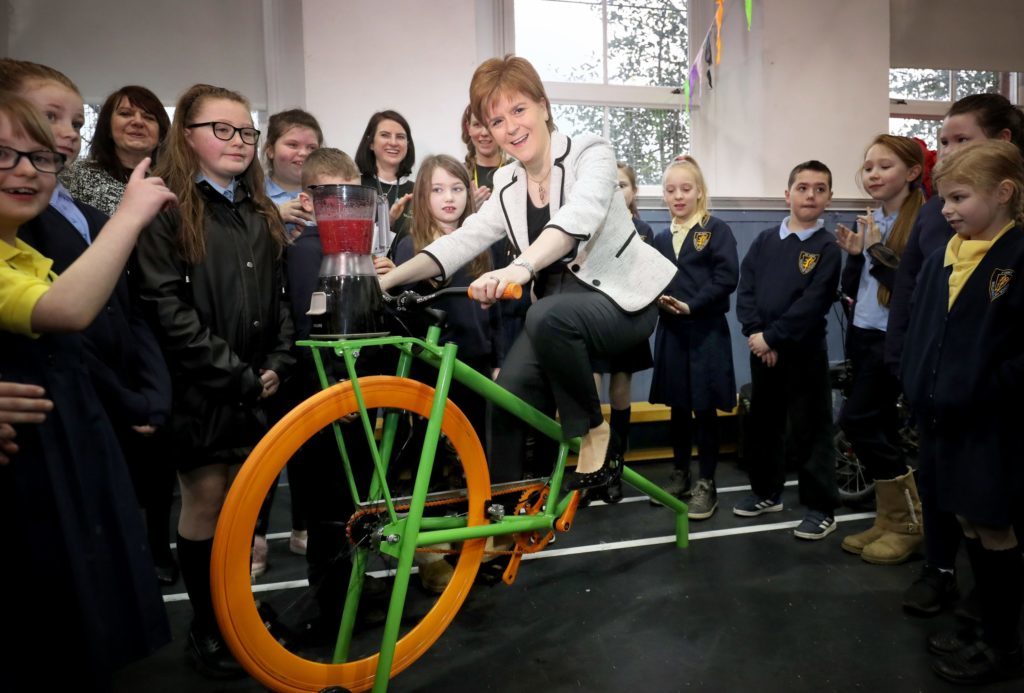 First Minister Nicola Sturgeon tries out a smoothie-making bike at Wellshot Primary School in Glasgow (Jane Barlow/PA)