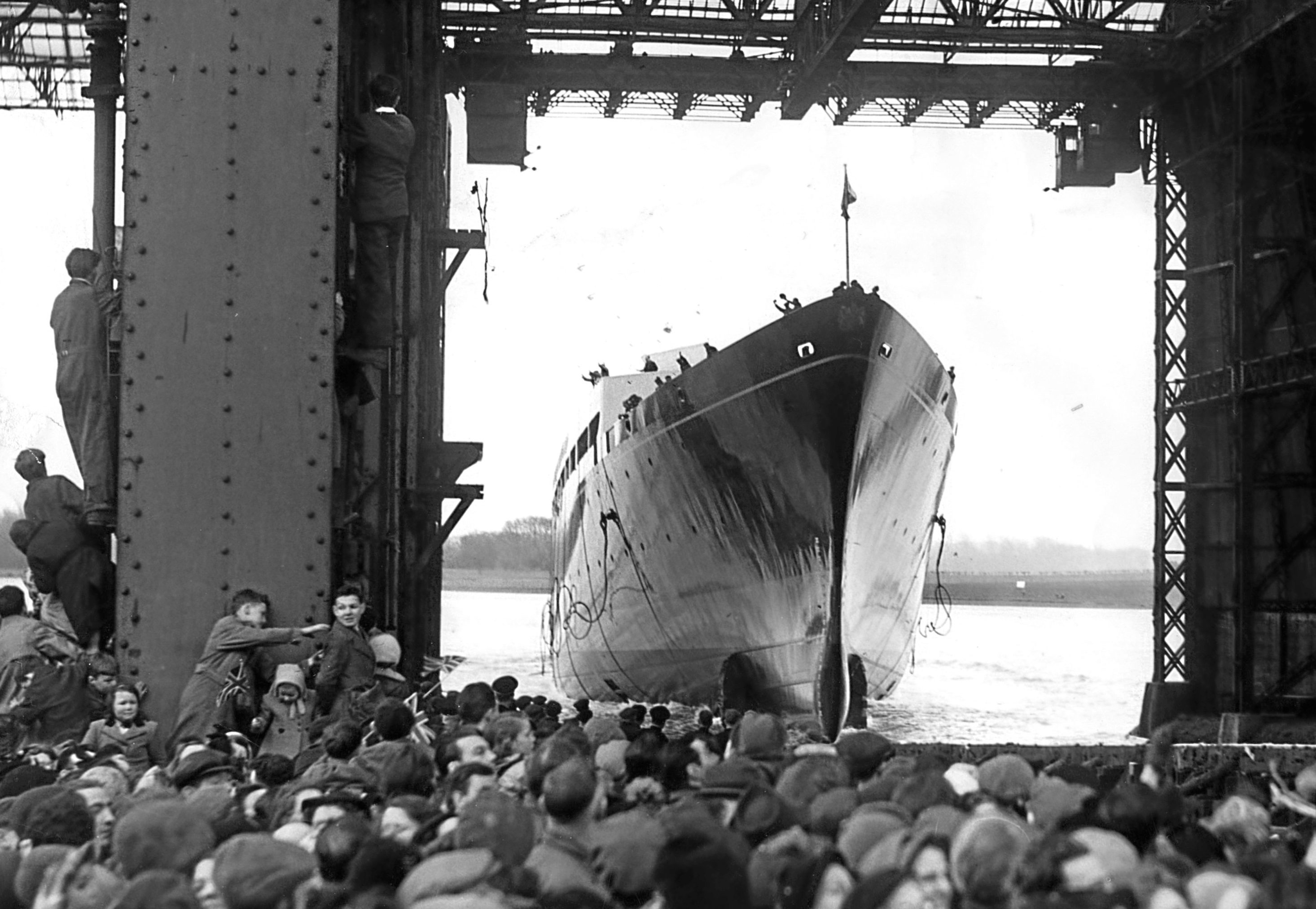 The new Royal Yacht Britannia enters the water after her launch by the Queen at John Brown's shipyards, Clydebank