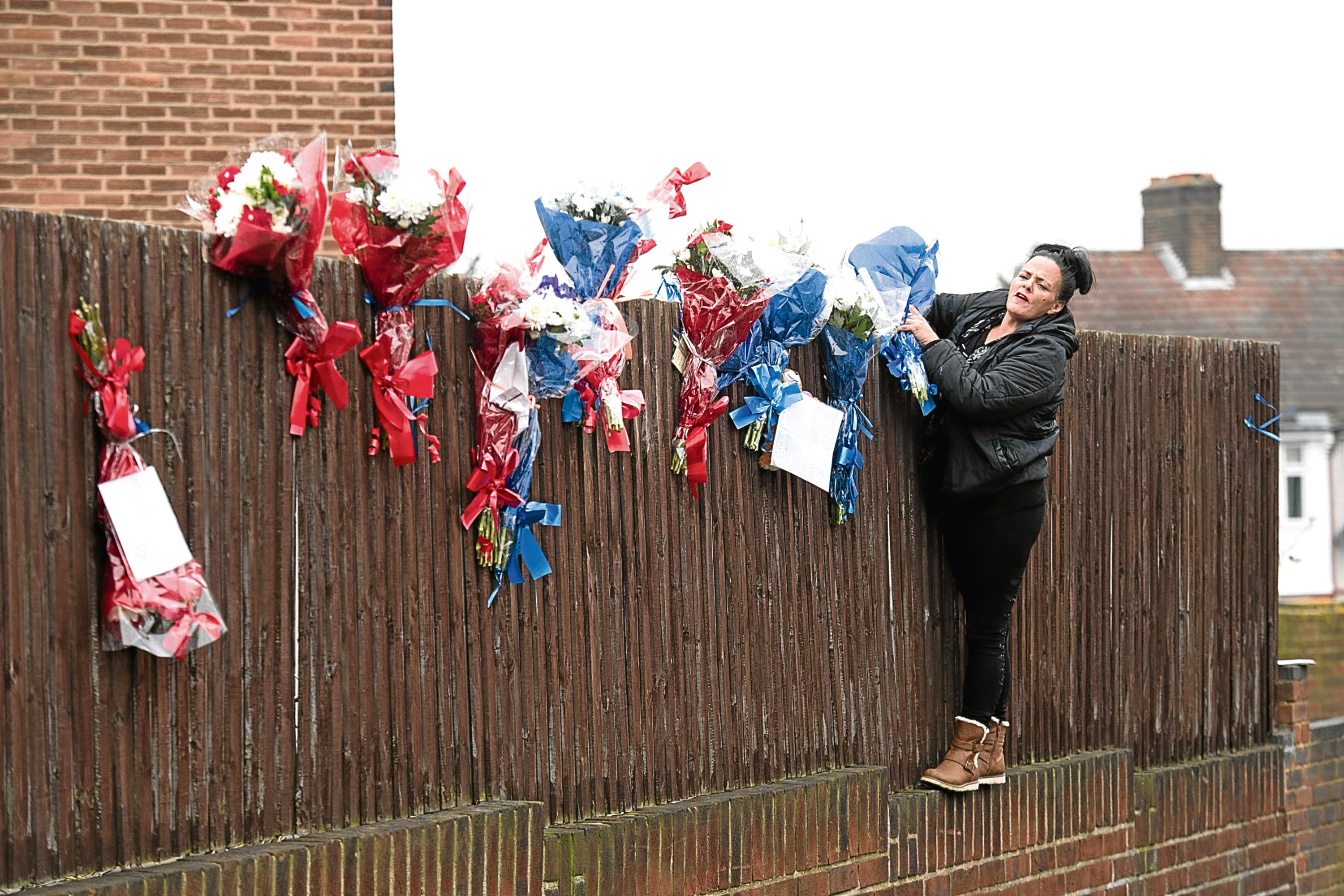 Flowers have been placed opposite the Brooks’ home (Stefan Rousseau/PA Wire)