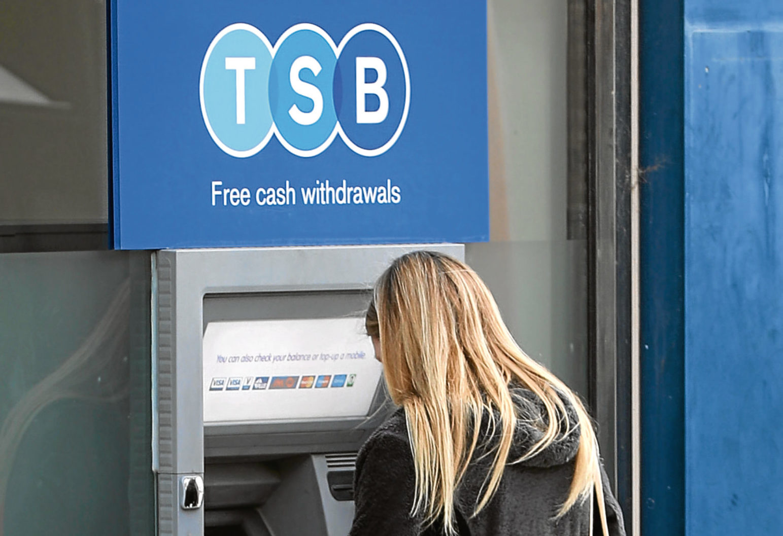 A woman uses a TSB cash machine (Gareth Fuller/PA Wire)