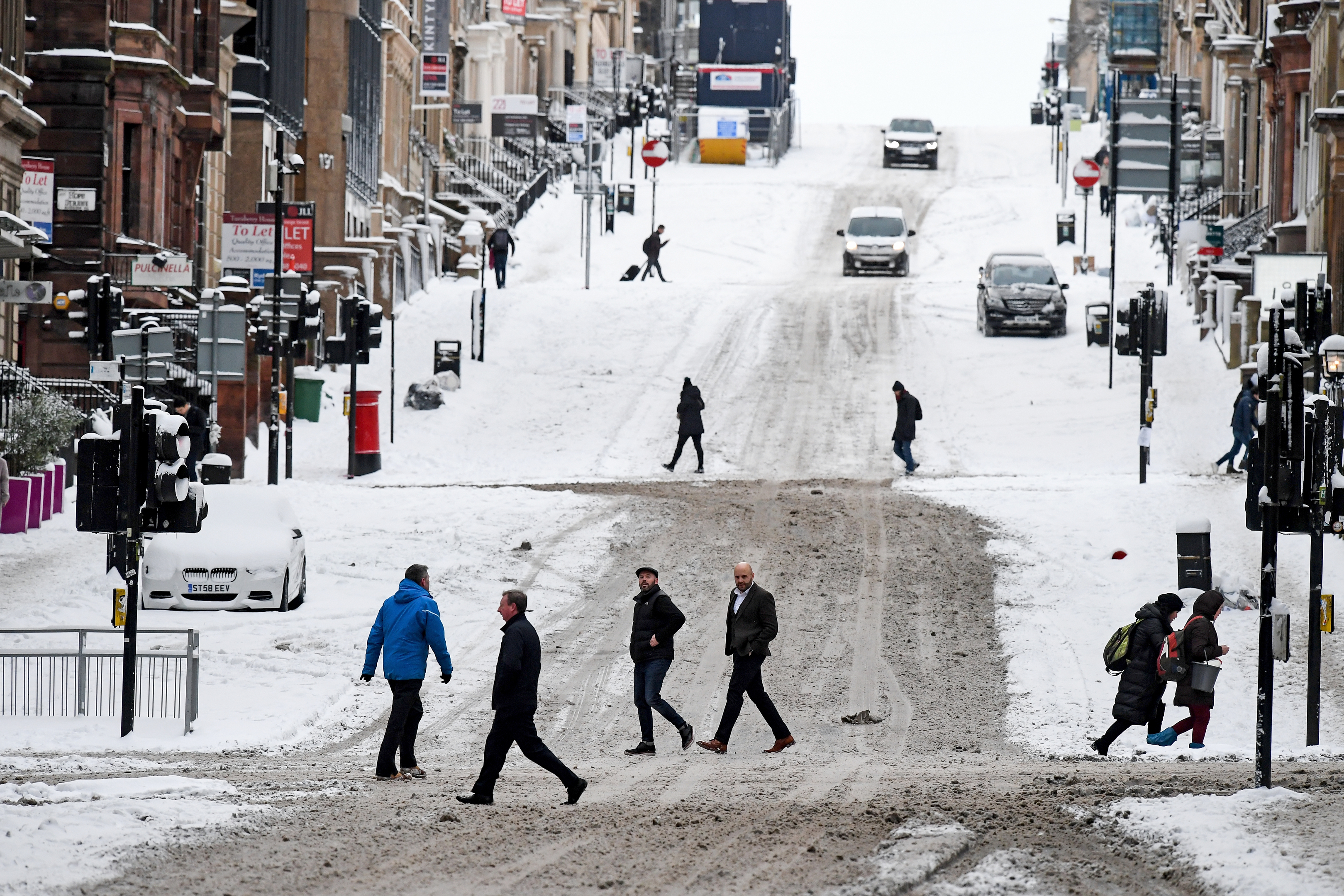 Members of the public make their way across West George Street on February 28, in Glasgow, Scotland. Freezing weather conditions dubbed the 'Beast from the East' bring snow and sub-zero temperatures to the UK (Jeff J Mitchell/Getty Images)