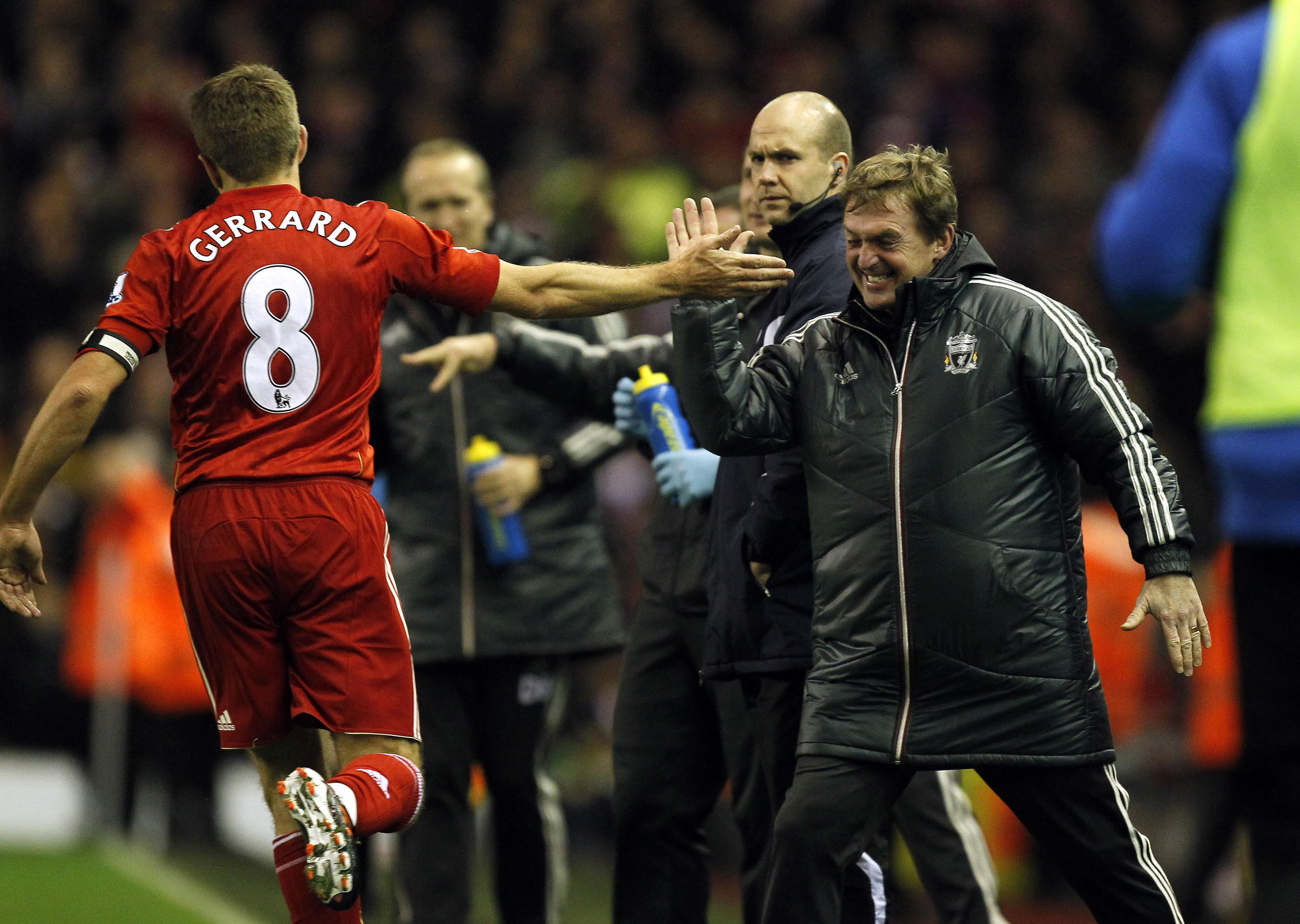 Liverpool's Steven Gerrard celebrates with manager Kenny Dalglish during a Premier League match at Anfield (PA Archive)