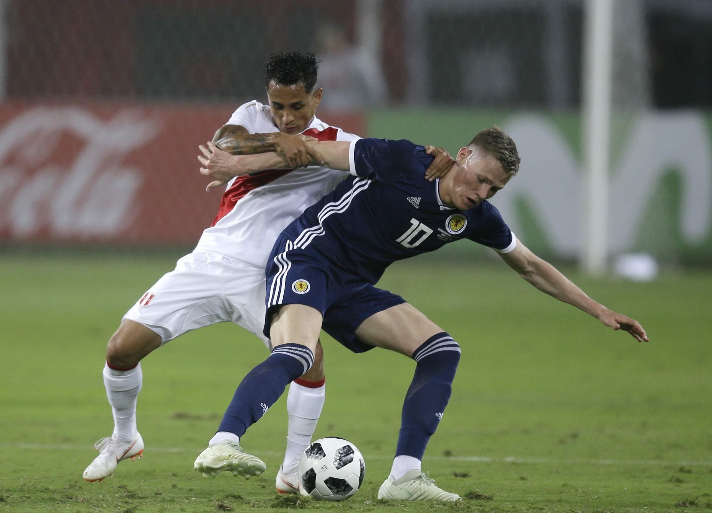 Peru's Yoshimar Yotun, left, fights for the ball with Scotland's Scott McTominay (AP Photo/Martin Mejia)