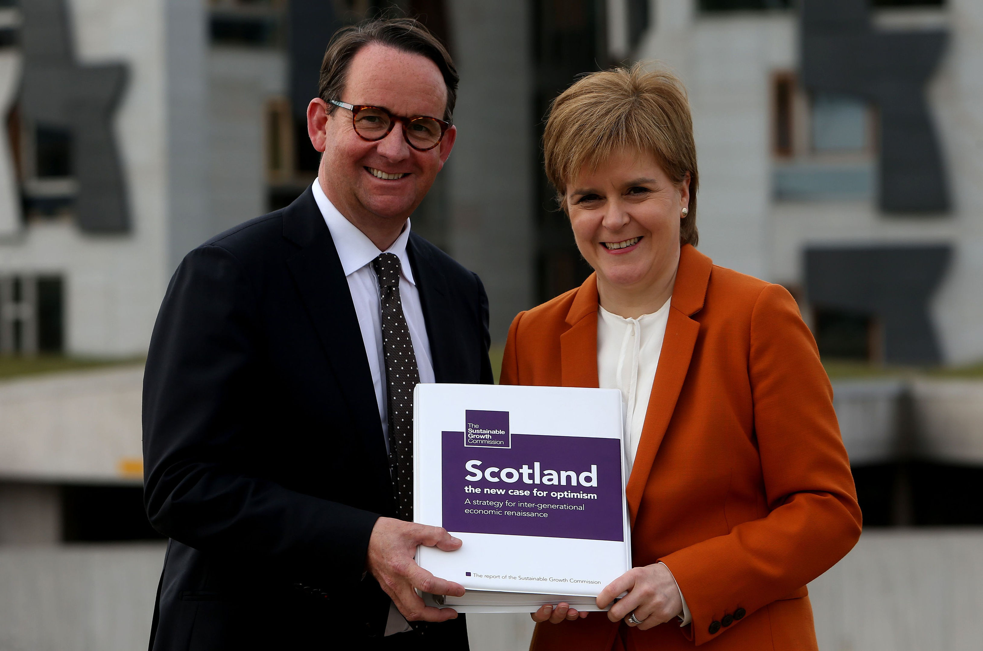 First Minister Nicola Sturgeon receives the Sustainable Growth Commission report from commission chair Andrew Wilson (Gordon Terris/The Herald/PA Wire)