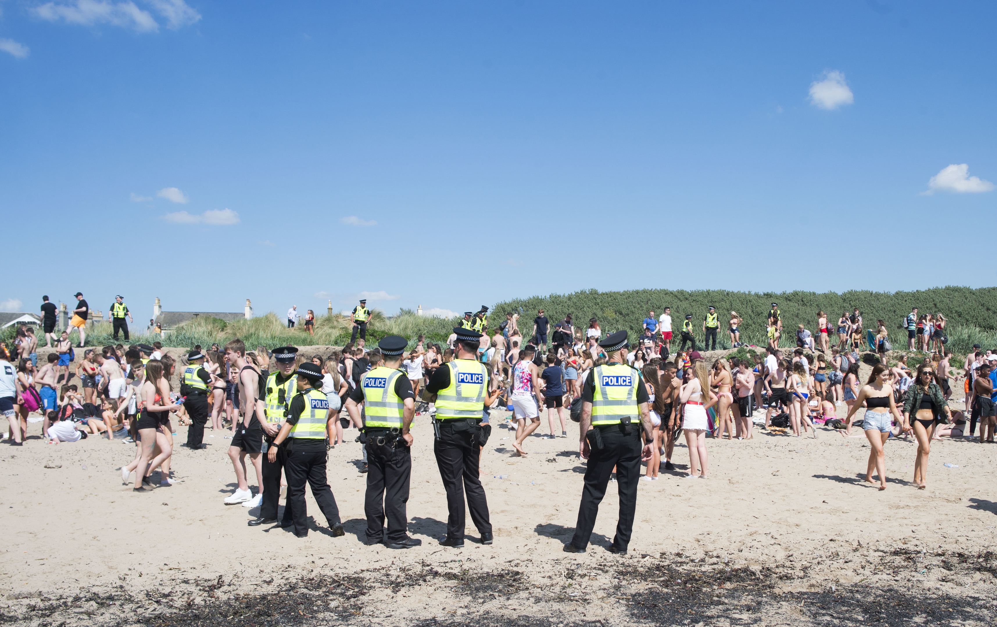 Police officers stand guard on Troon Beach last week as temperatures soar on Bank Holiday Monday (John Kirkby)