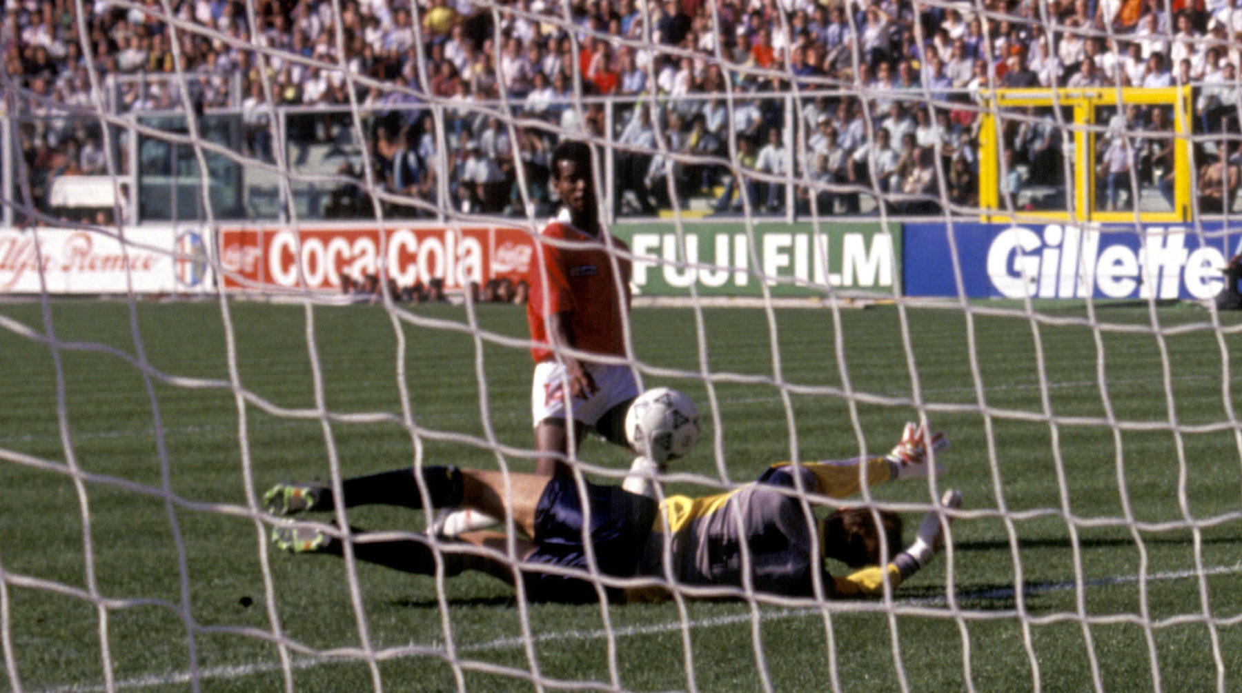 Costa Rica's Juan Cayasso chips the ball over Scotland's Jim Leighton to score the only goal of the game