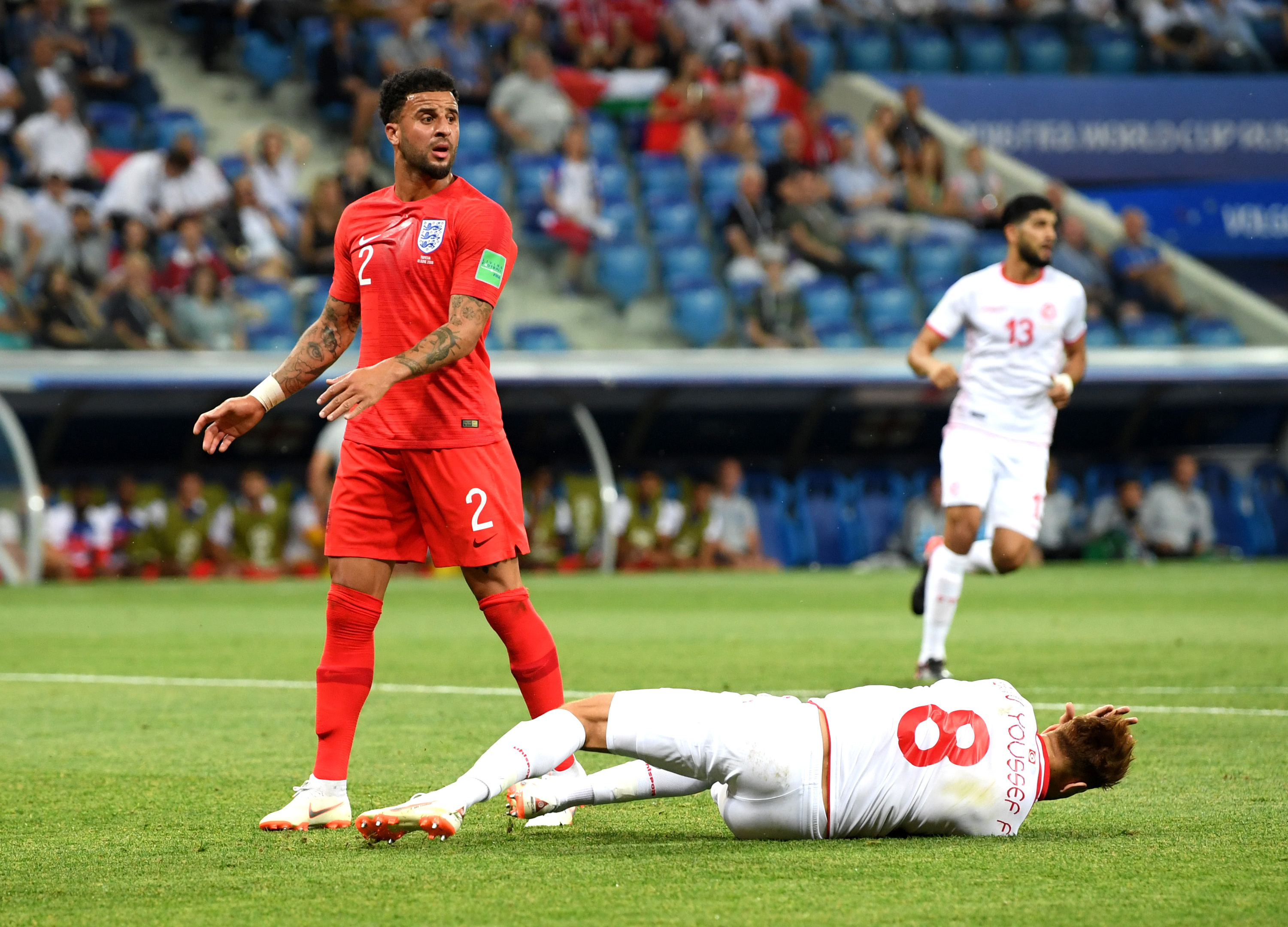 Fakhreddine Ben Youssef of Tunisia goes down in penalty area under challenge from Kyle Walker (Matthias Hangst/Getty Images)