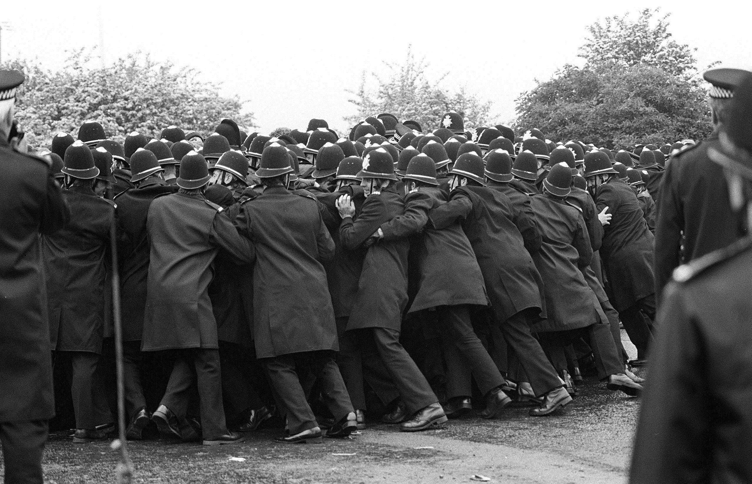police officers pushing against striking miners outside the Orgreave Coking Plant (PA Wire)