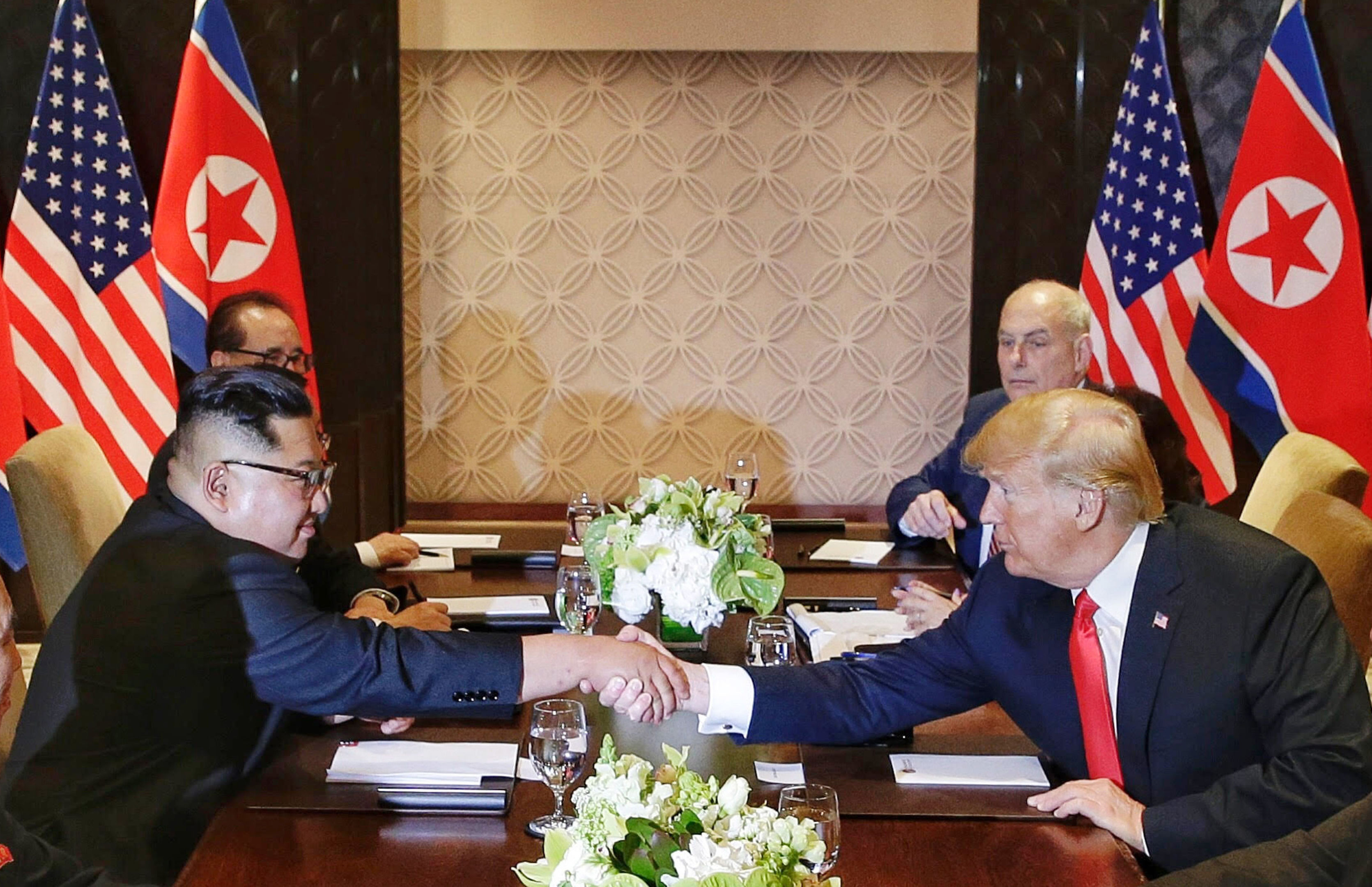 U.S. President Donald Trump shakes hands with North Korean leader Kim Jong Un during their meeting (Kevin Lim/The Straits Times via AP)