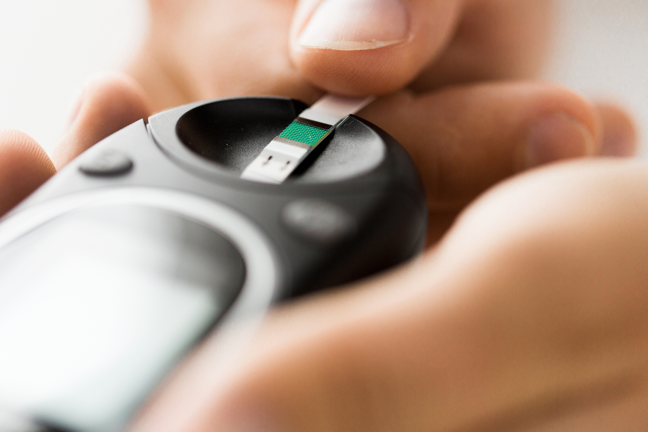 Checking blood sugar level by glucometer and test stripe (Getty Images)