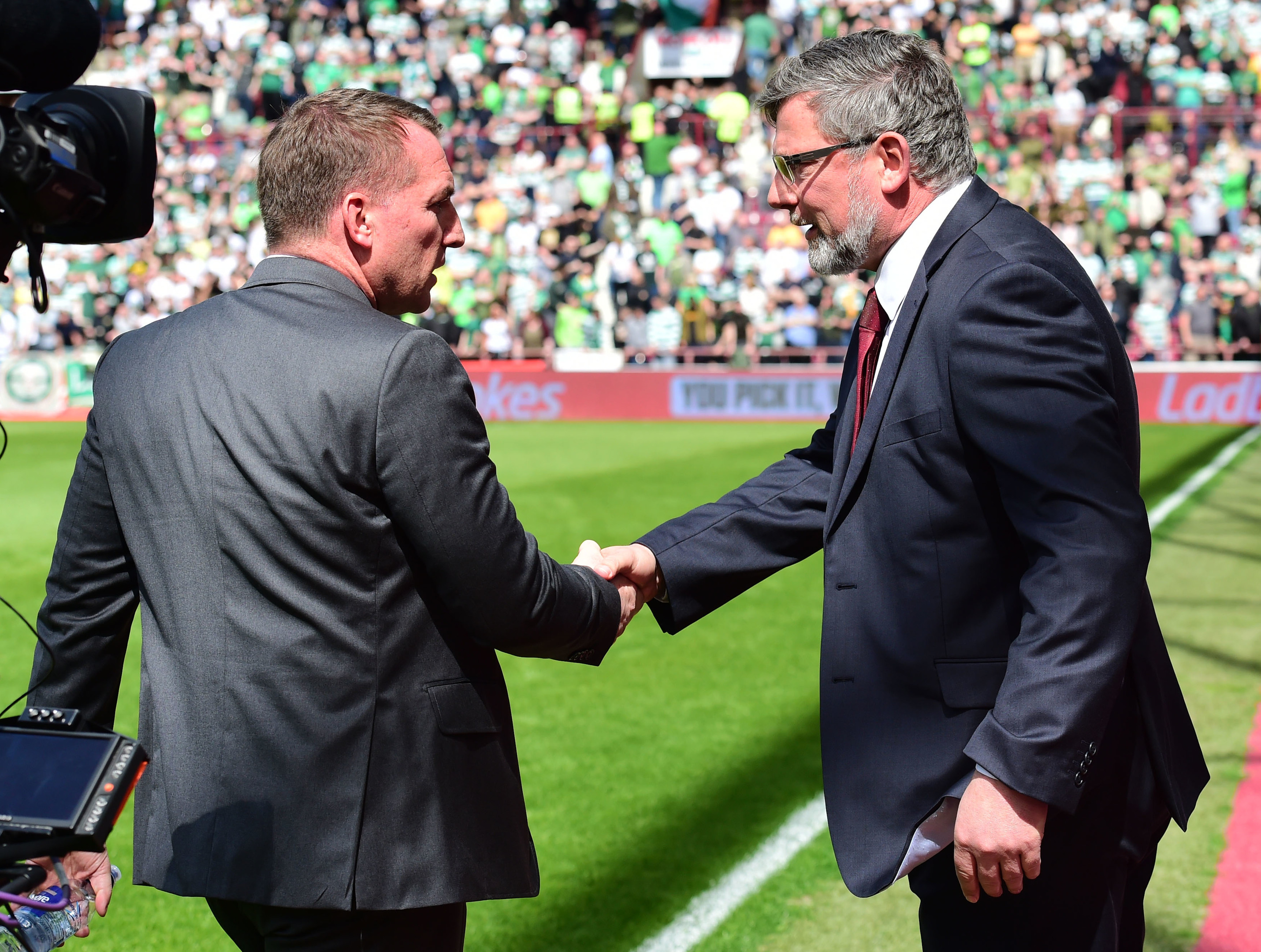 Celtic manager Brendan Rodgers (L) shakes hands with Hearts manager Craig Levein ahead of kick-off.