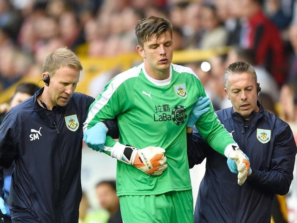 Burnley goalkeeper Nick Pope was escorted off the pitch injured at Pittodrie (PA Wires)