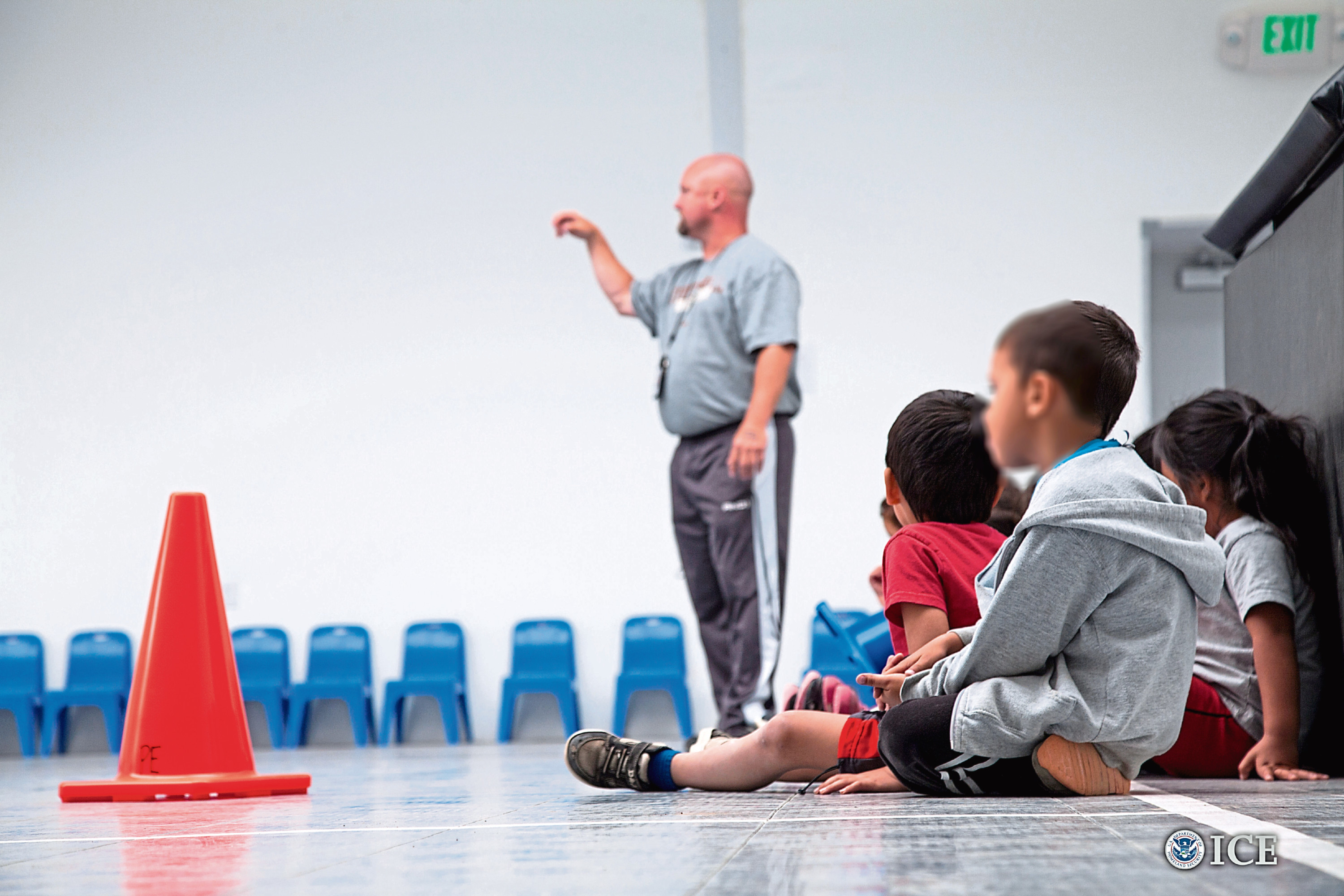 Children prepare to play inside gym at the STFRC in Dilley, Texas.