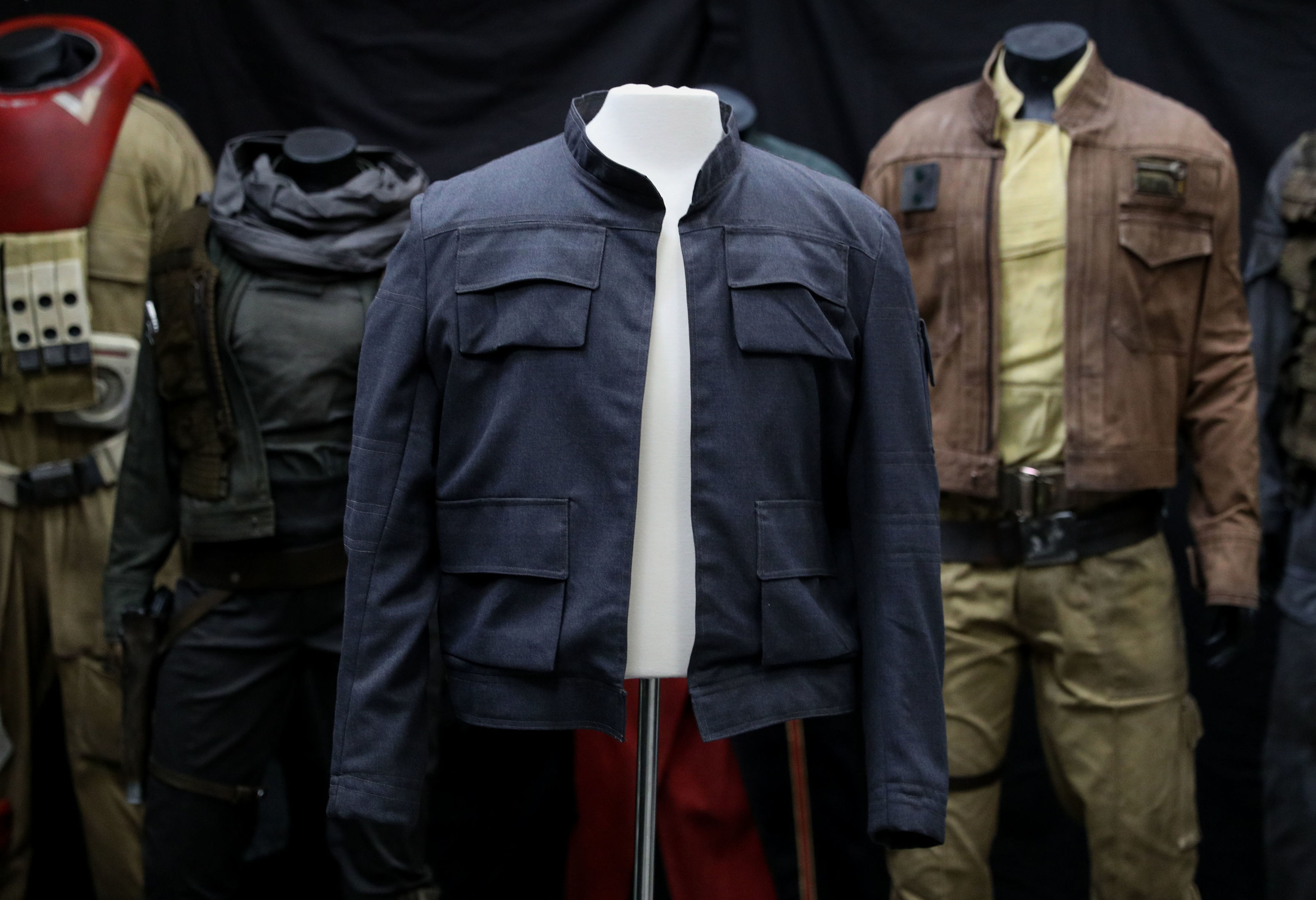Han Solo's jacket, as worn by Harrison Ford in Star Wars: The Empire Strikes Back on display in front of costumes from Rogue One: A Star Wars Story (Andrew Matthews/PA Wire)