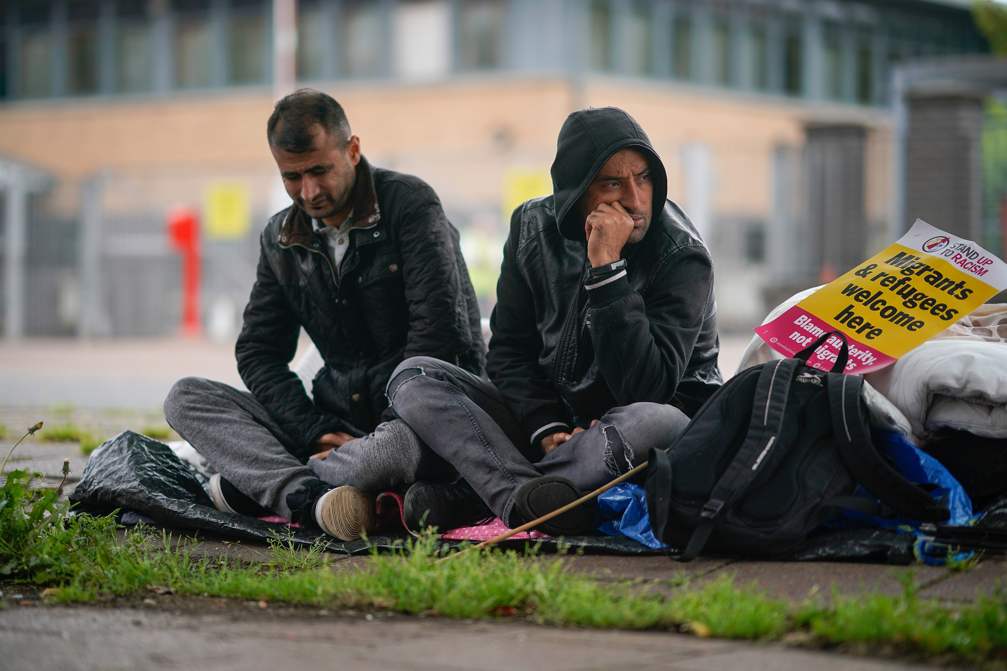 Afghan refugee Rahman Sahah (R) aged 32 and Mirwais Ahmadzai, 27, start their hunger strike outside the H.M. Government Home Office on August 1, 2018 in Glasgow, Scotland. Both men have requested asylum in the UK which has been refused. The two men are tenants of social housing provider Serco and face possible eviction.