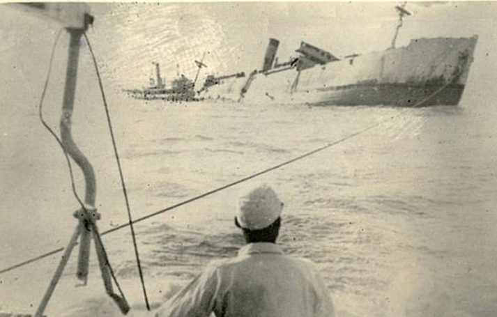 Chinese fishermen watch as the Lisbon Maru lists and sinks beneath the sea