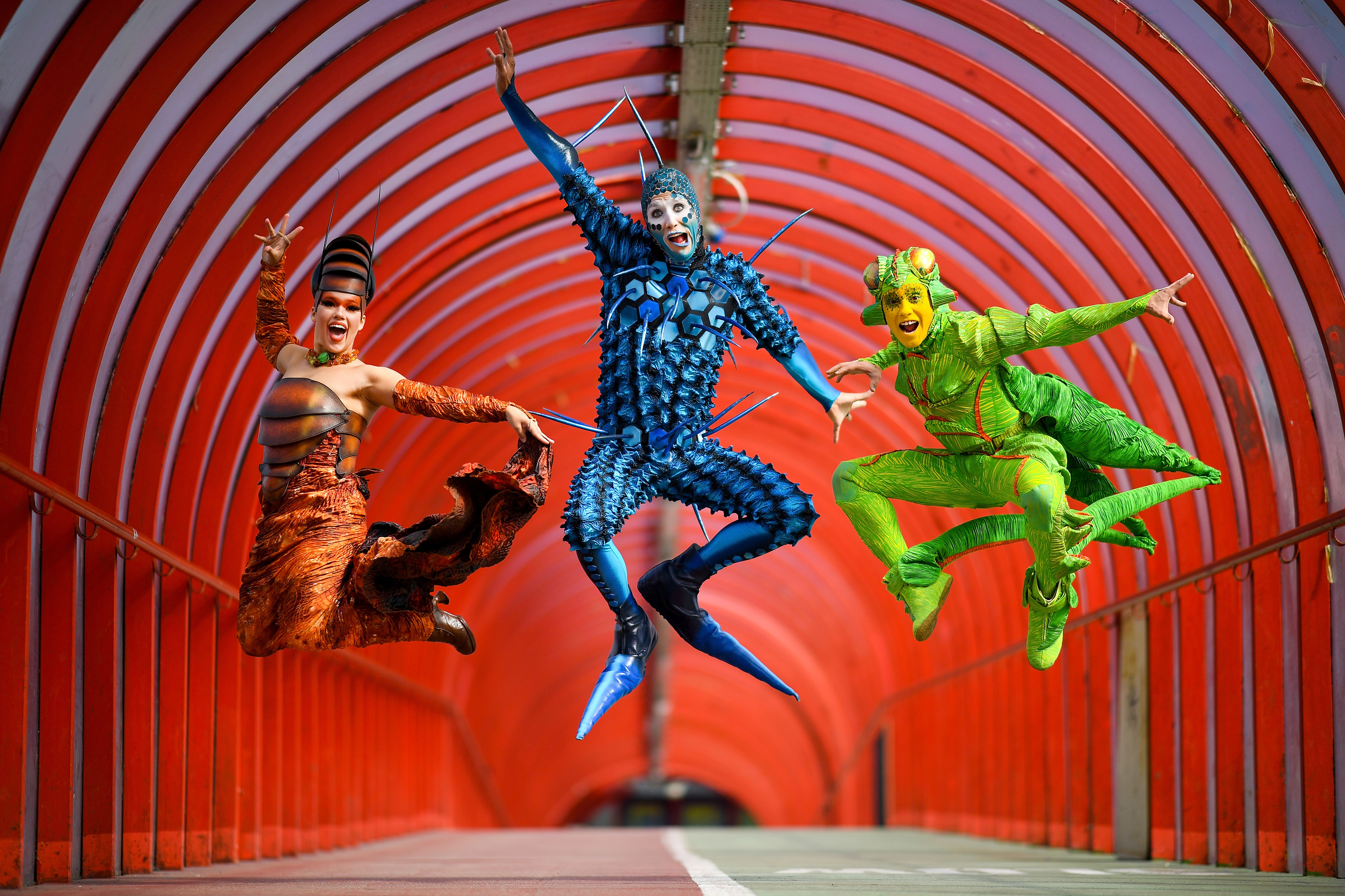 Cirque du Soleil’s Julia Tazie, Jan Duther and Nathan Rivera-Drydak perform in the “Smartie Tube” walkway in Glasgow (Jeff J Mitchell/Getty Images)