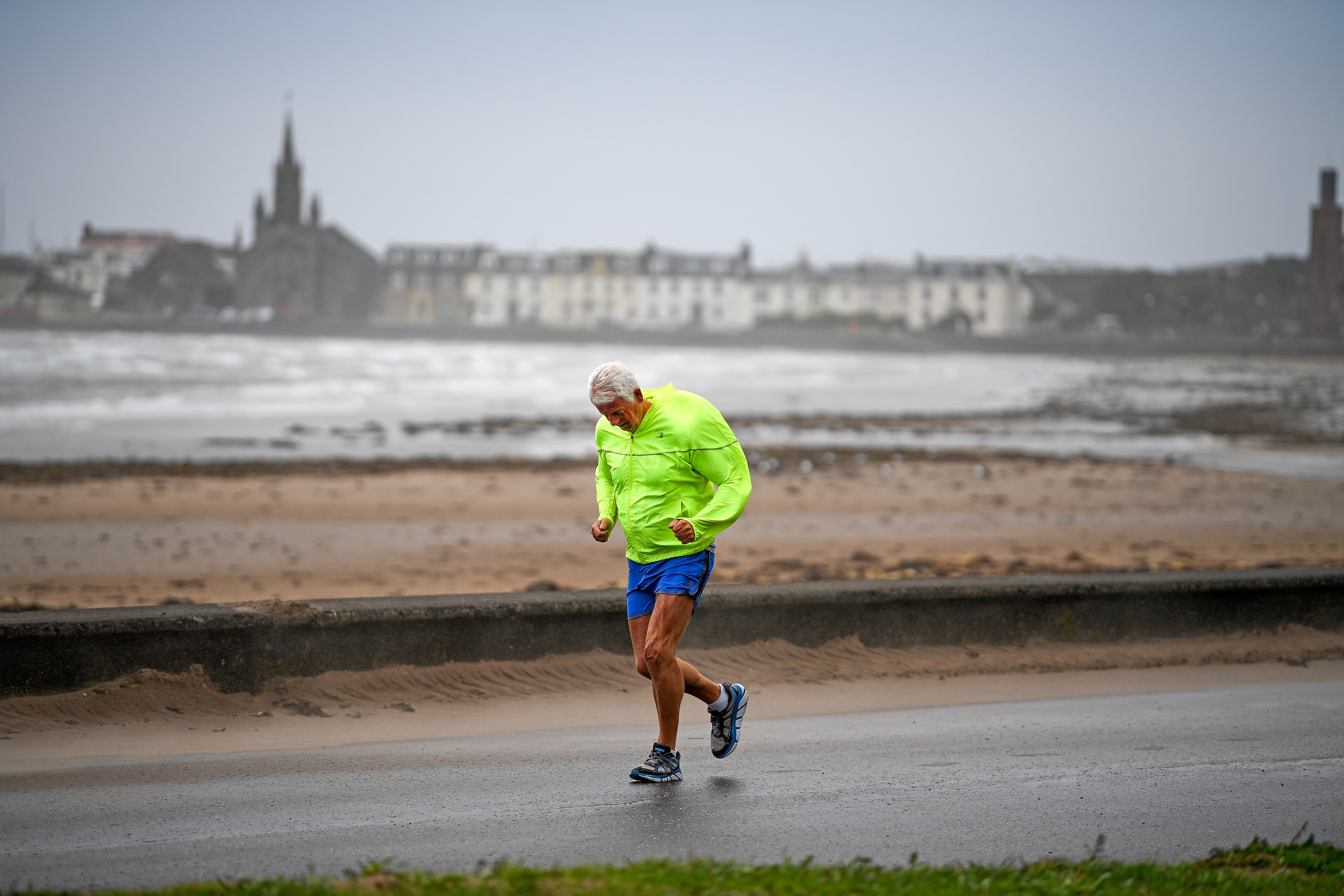 A member of the public struggles in the wind as he goes for a run as Storm Ali hits land at Saltcoats (Jeff J Mitchell/Getty Images)
